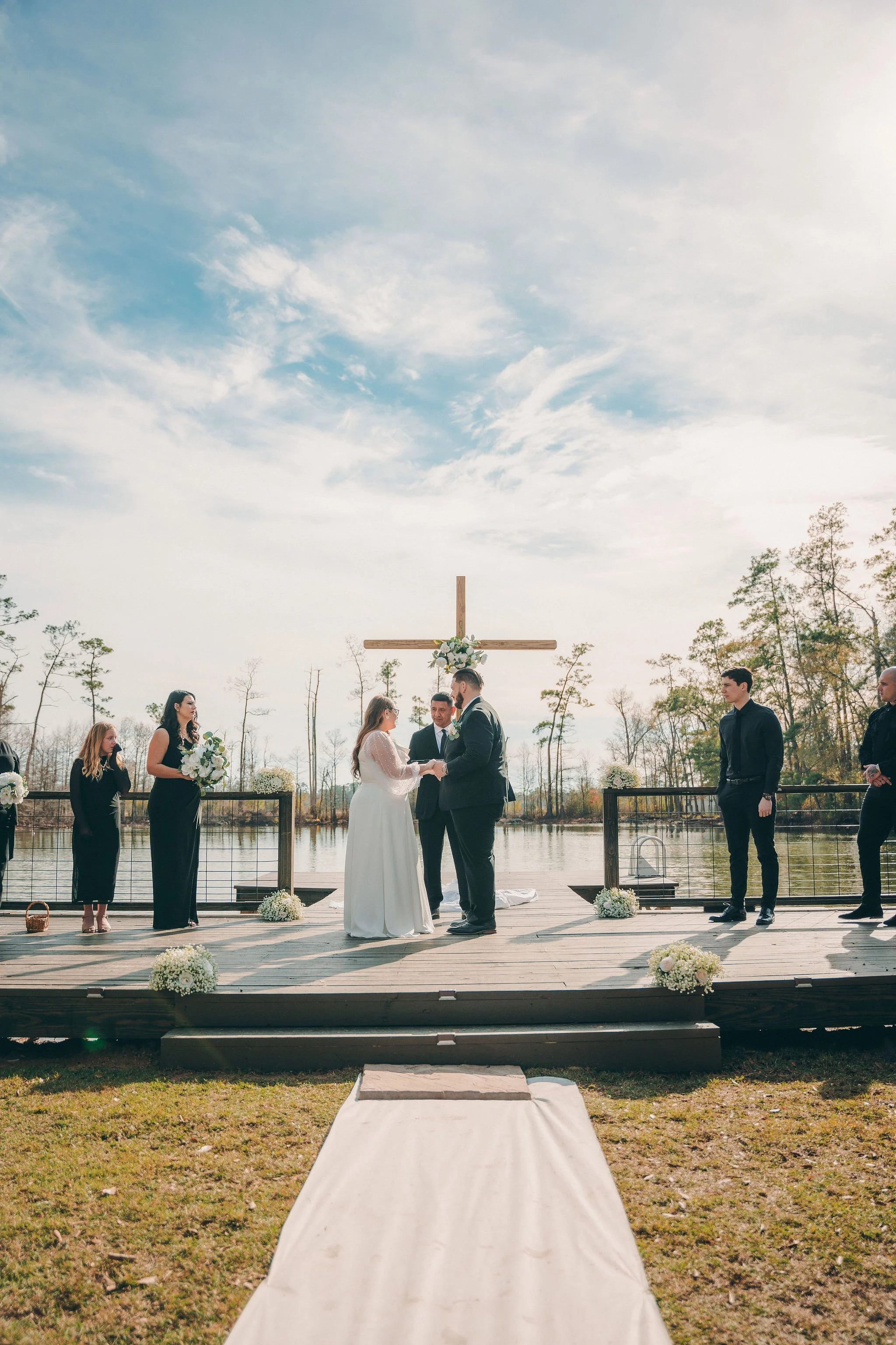 wedding ceremony with a big cross in the center