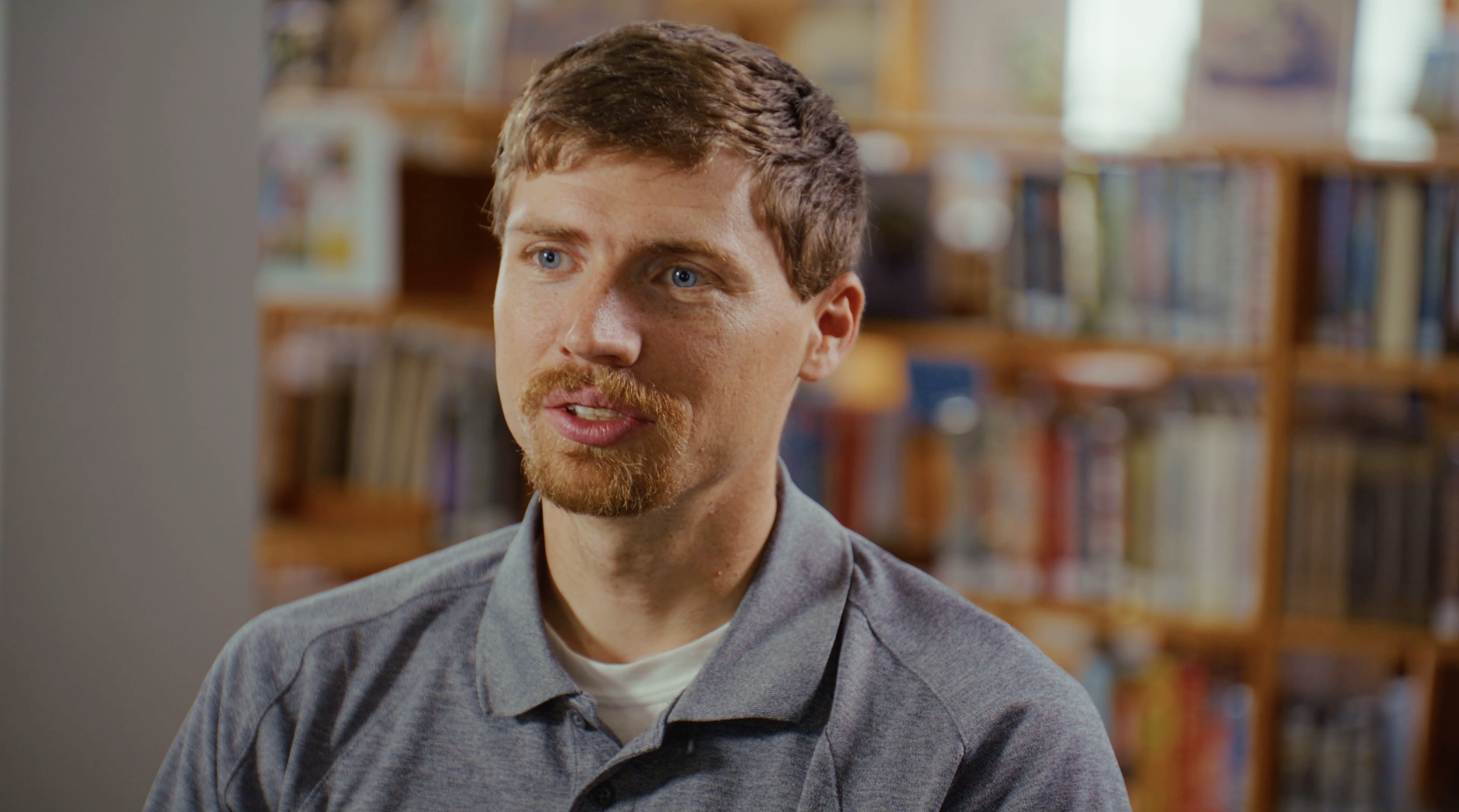 Jonathan Jockey sitting down in a library for an interview
