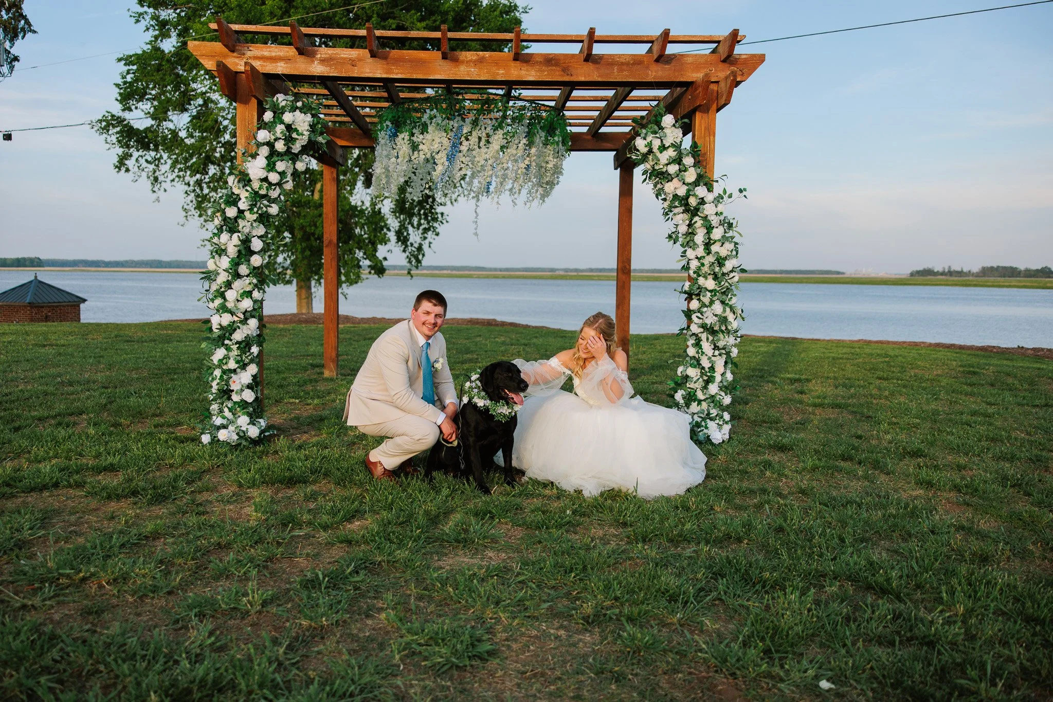 married couple kneeling for a picture with thier dog in virginia