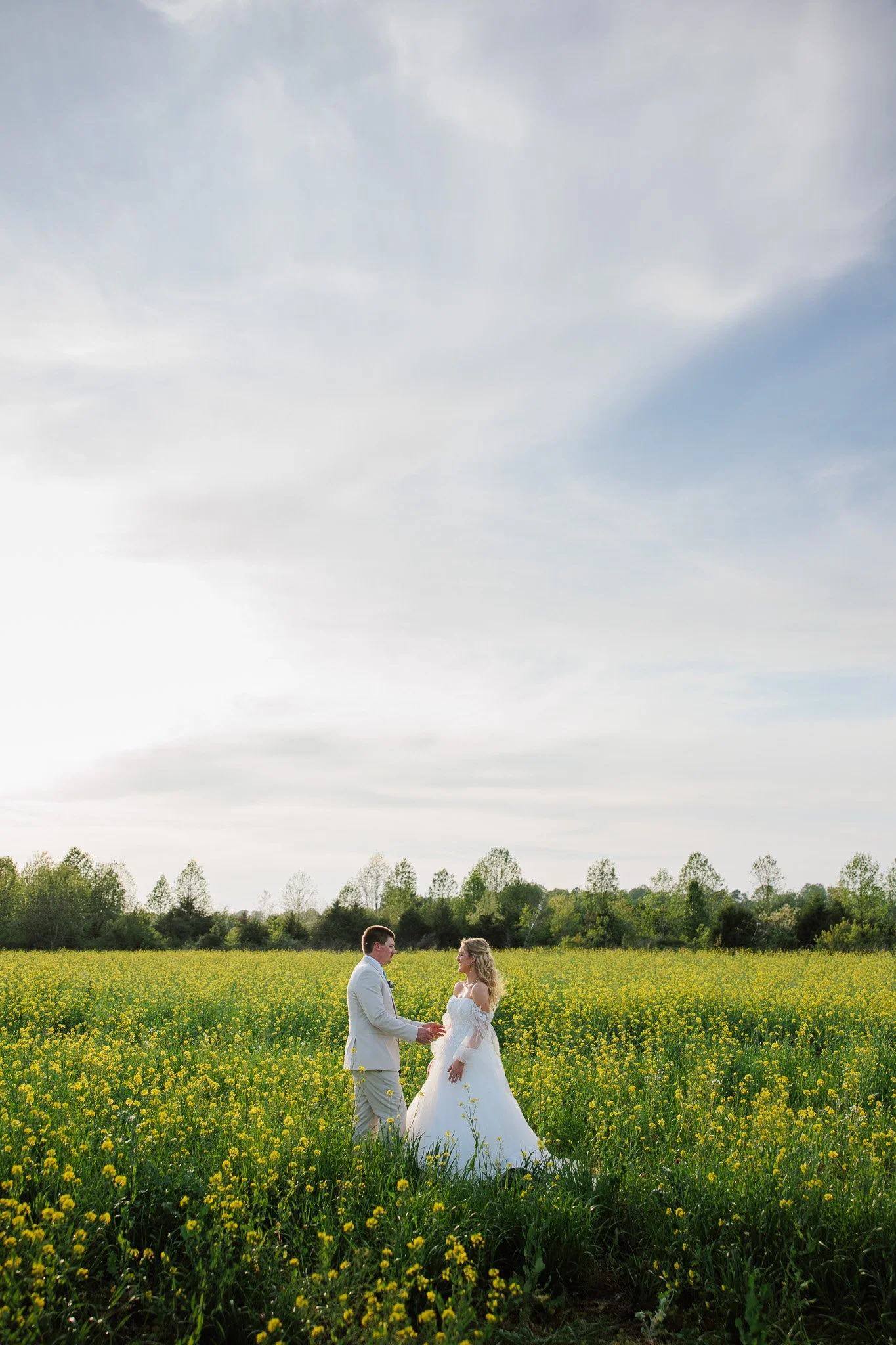 married couple standing in a sunflower field in virginia