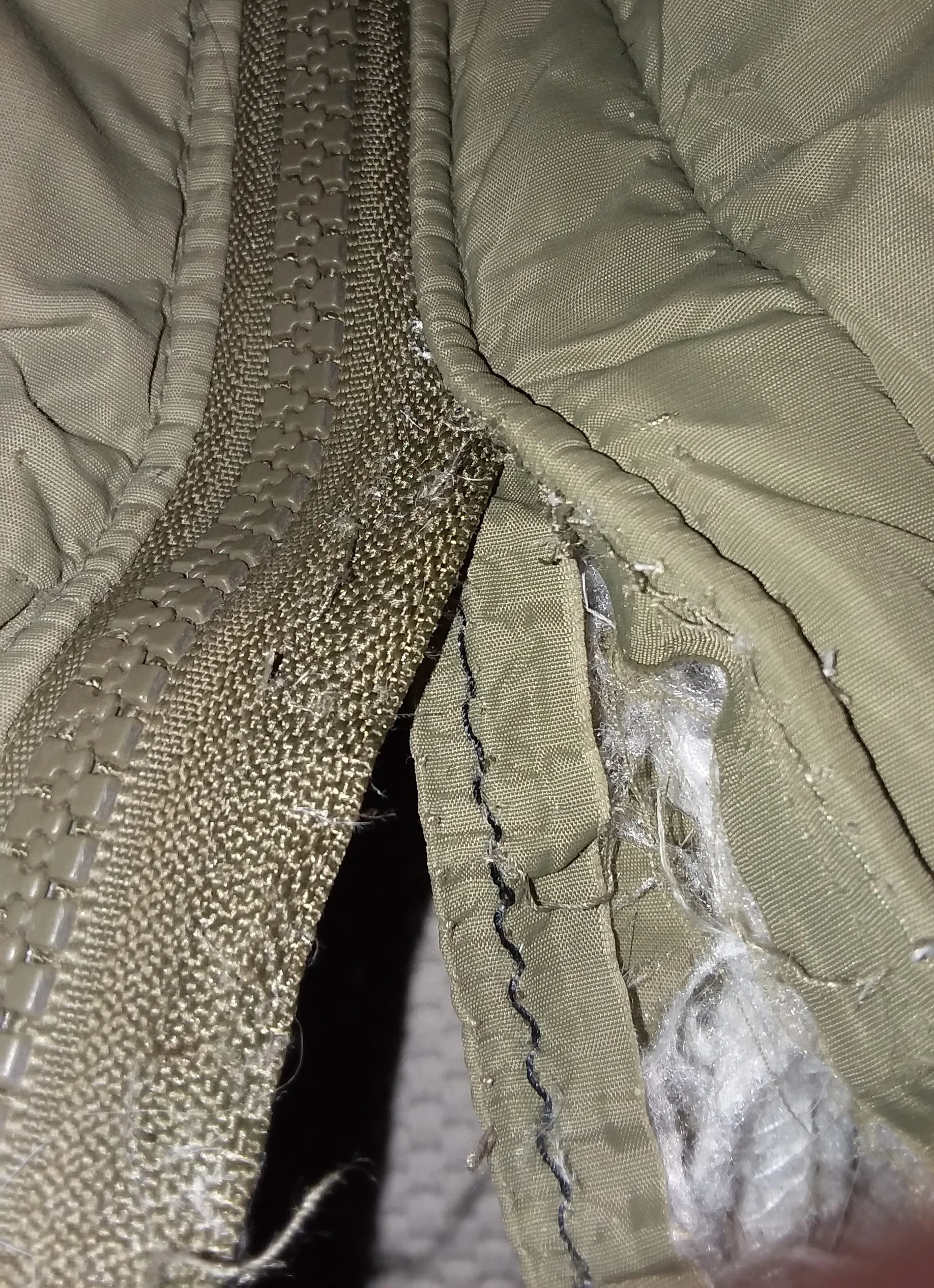 The old zipper is about halfway out on one side in this picture. See what I mean by an eviscerated coat?