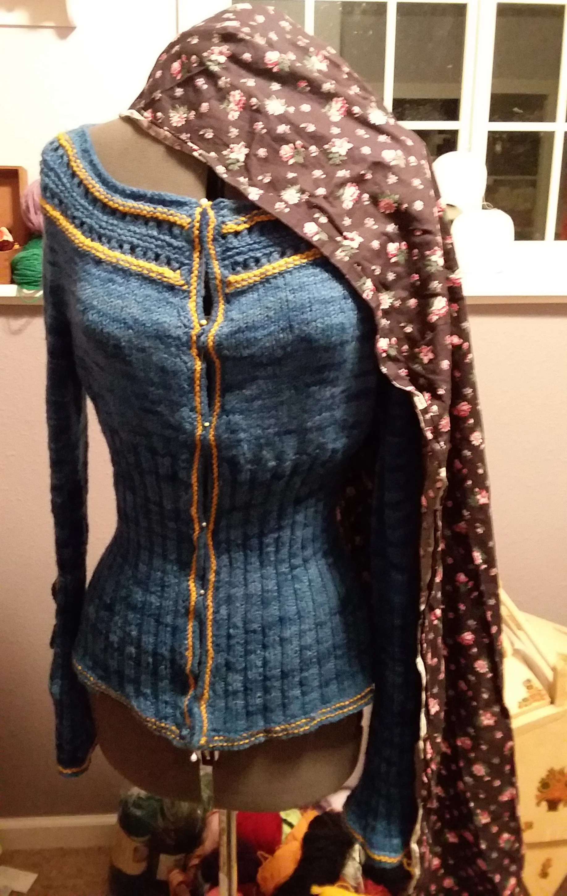 Here you can see her before I added the crochet trim to the neckline. Even on the mannequin, it wants to slip down the shoulders. I blocked the whole sweater on the form which made a world of difference.