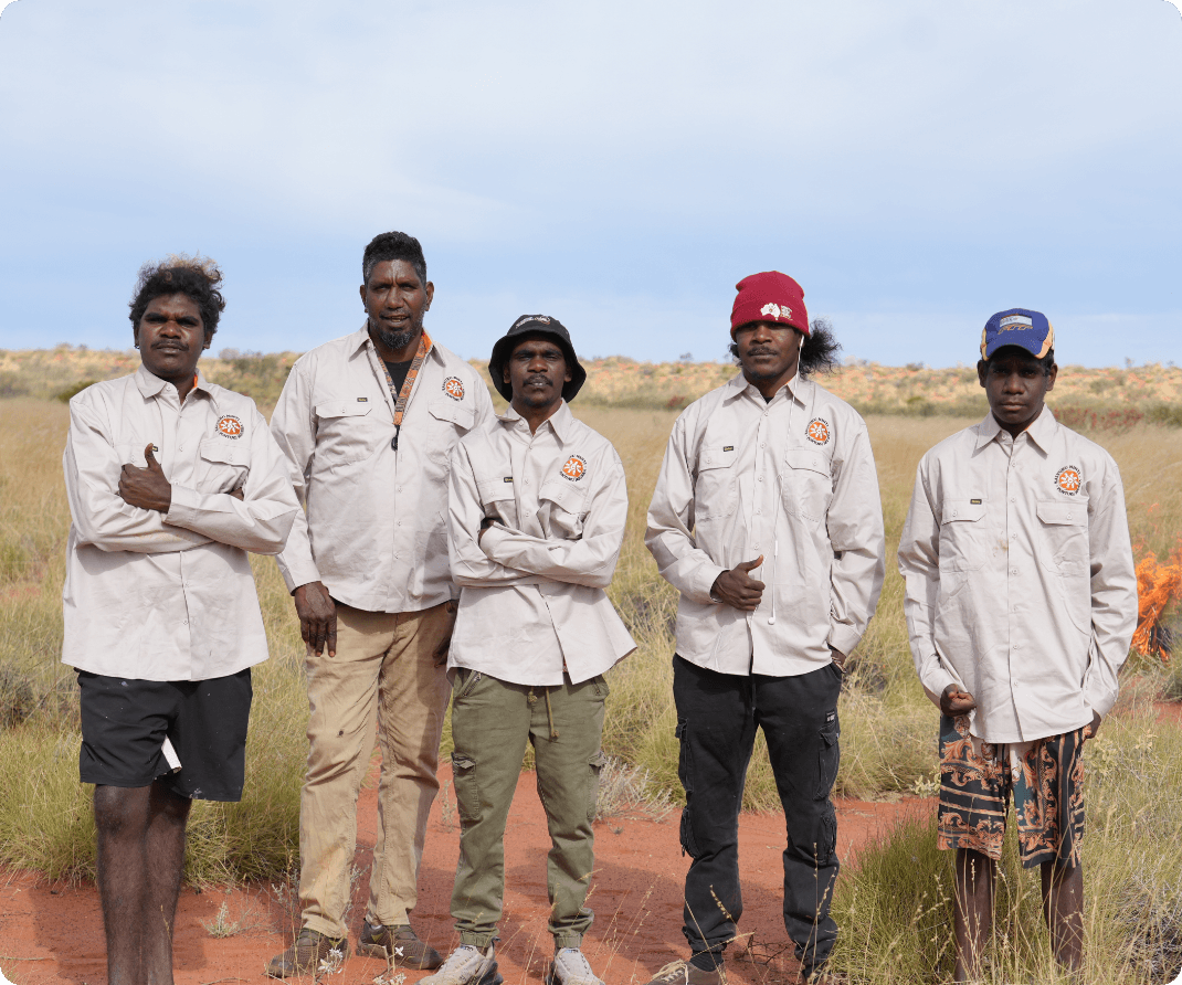 Group of young KJ Martu men and mentor working together on Country, representing KJ's work building pathways for young Martu people to stay strong in both worlds