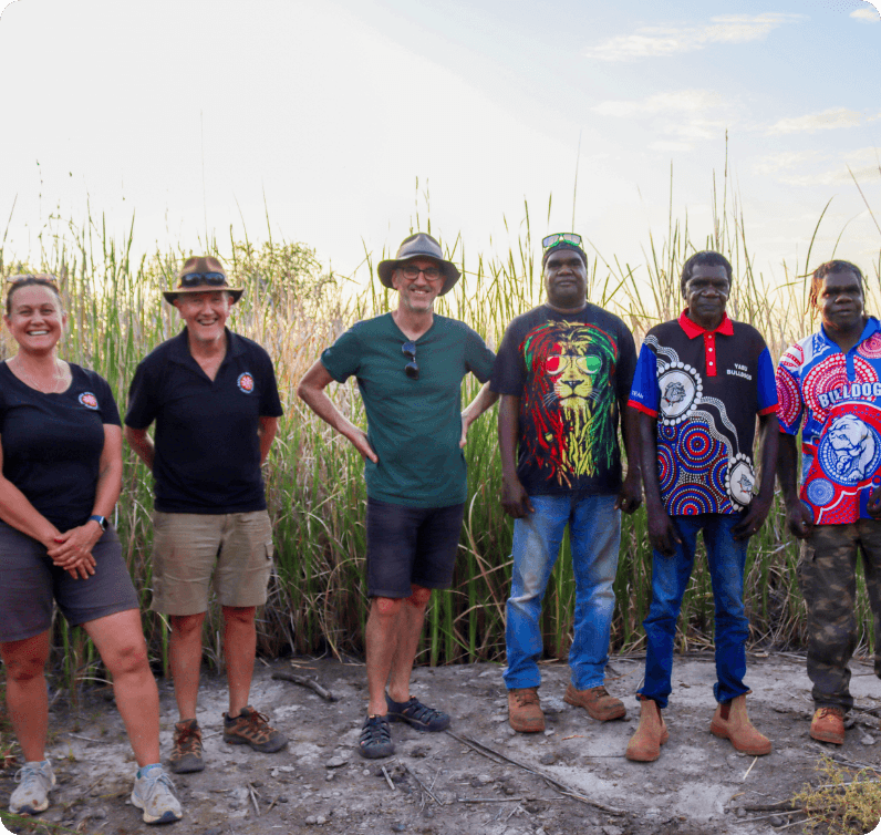 Martu and non-Martu KJ board members and directors standing together on Country, representing KJ's Martu-led governance structure