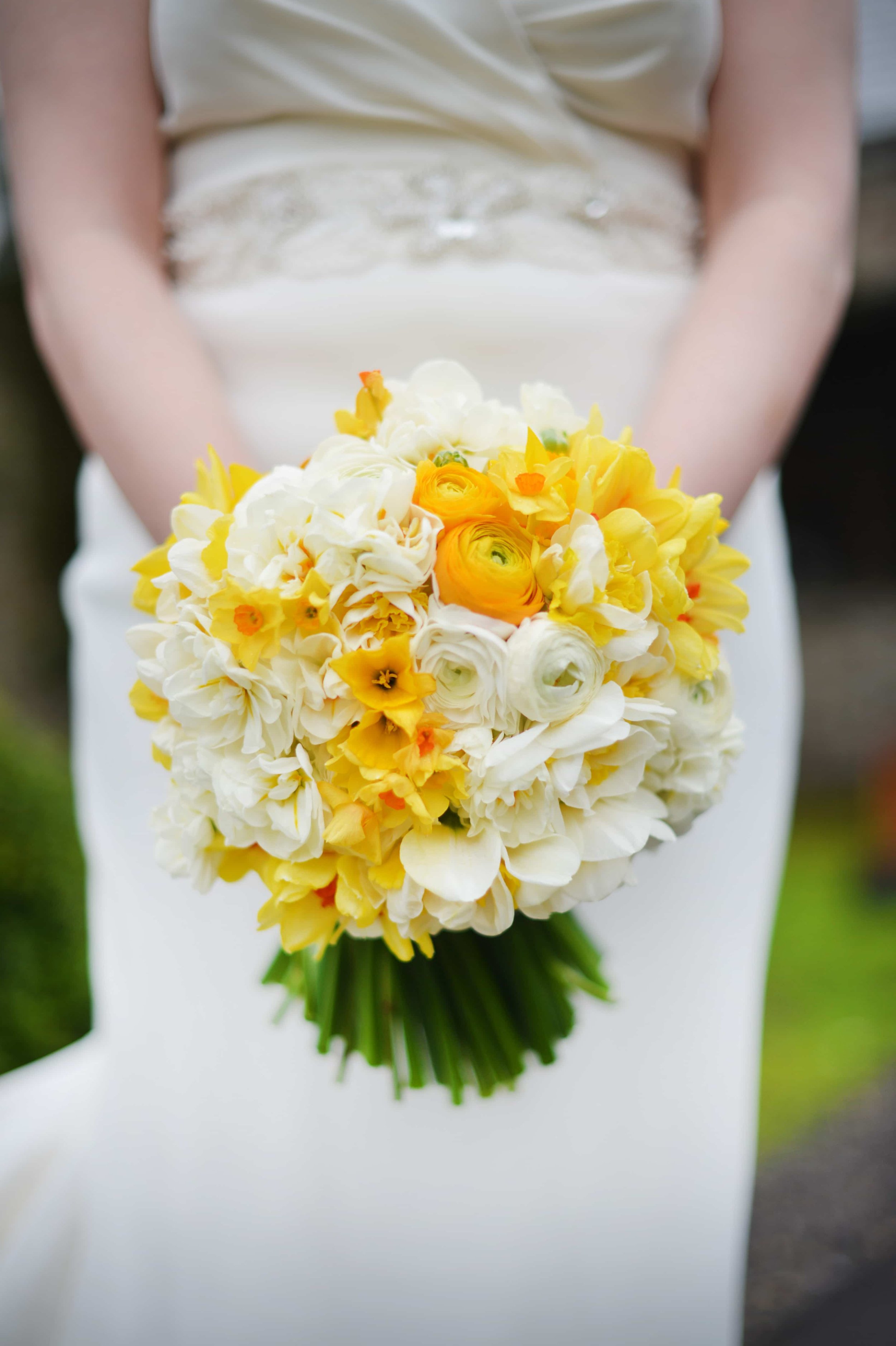 Spring bouquet with yellow and white daffodils and ranunculus.