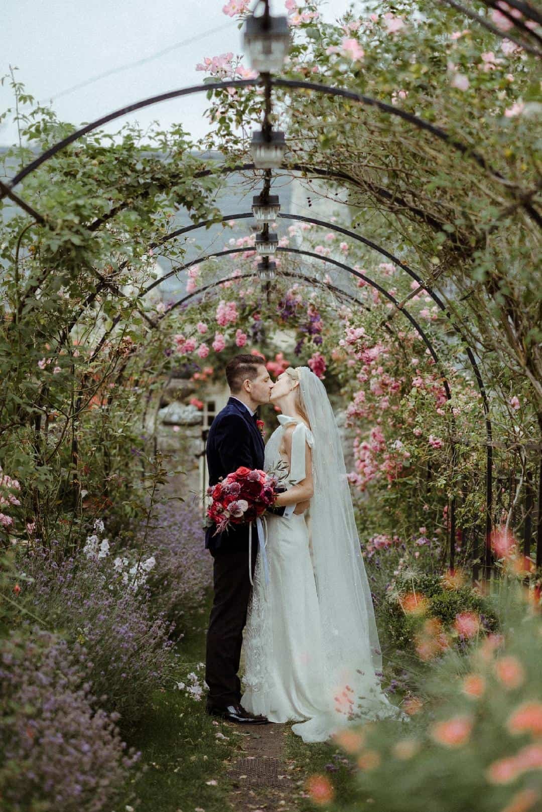 first kiss holding wedding flowers.jpg