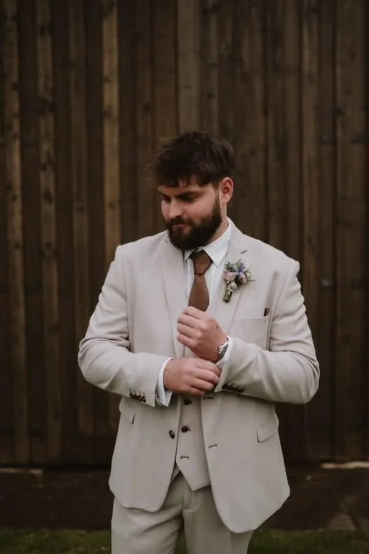 The groom with summer buttonhole at Sugarloaf Barn.jpg