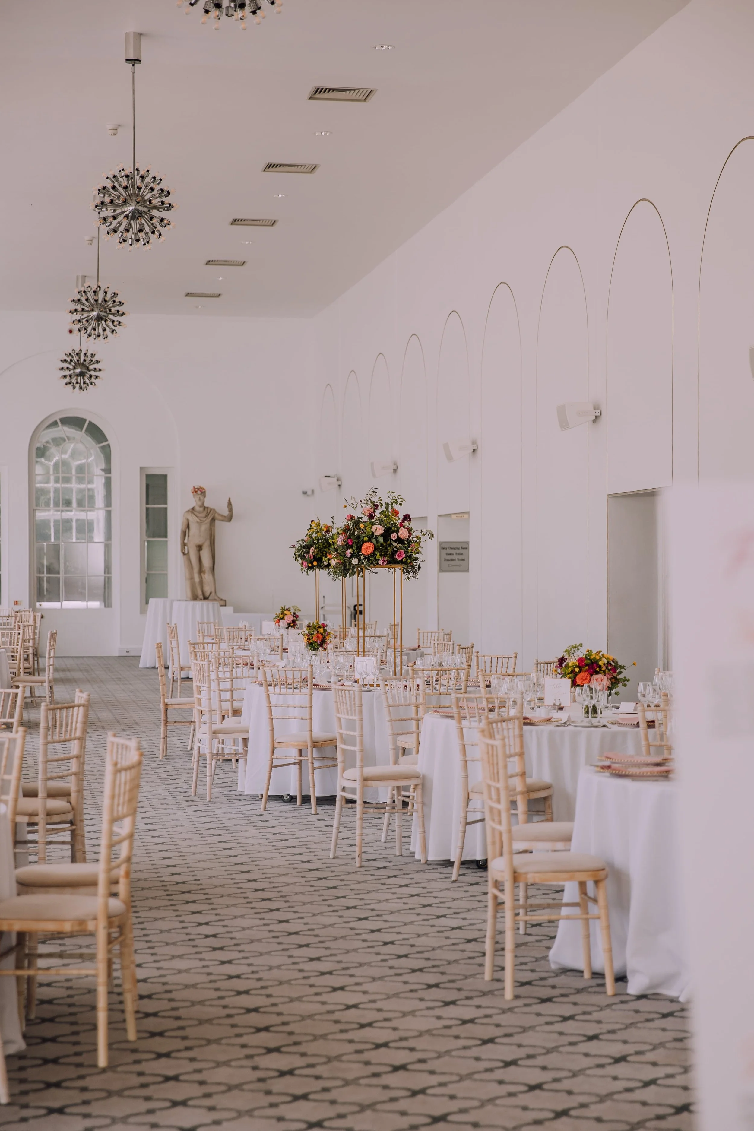 Margam Orangery with colourful elevated wedding flower centrepiece.jpg
