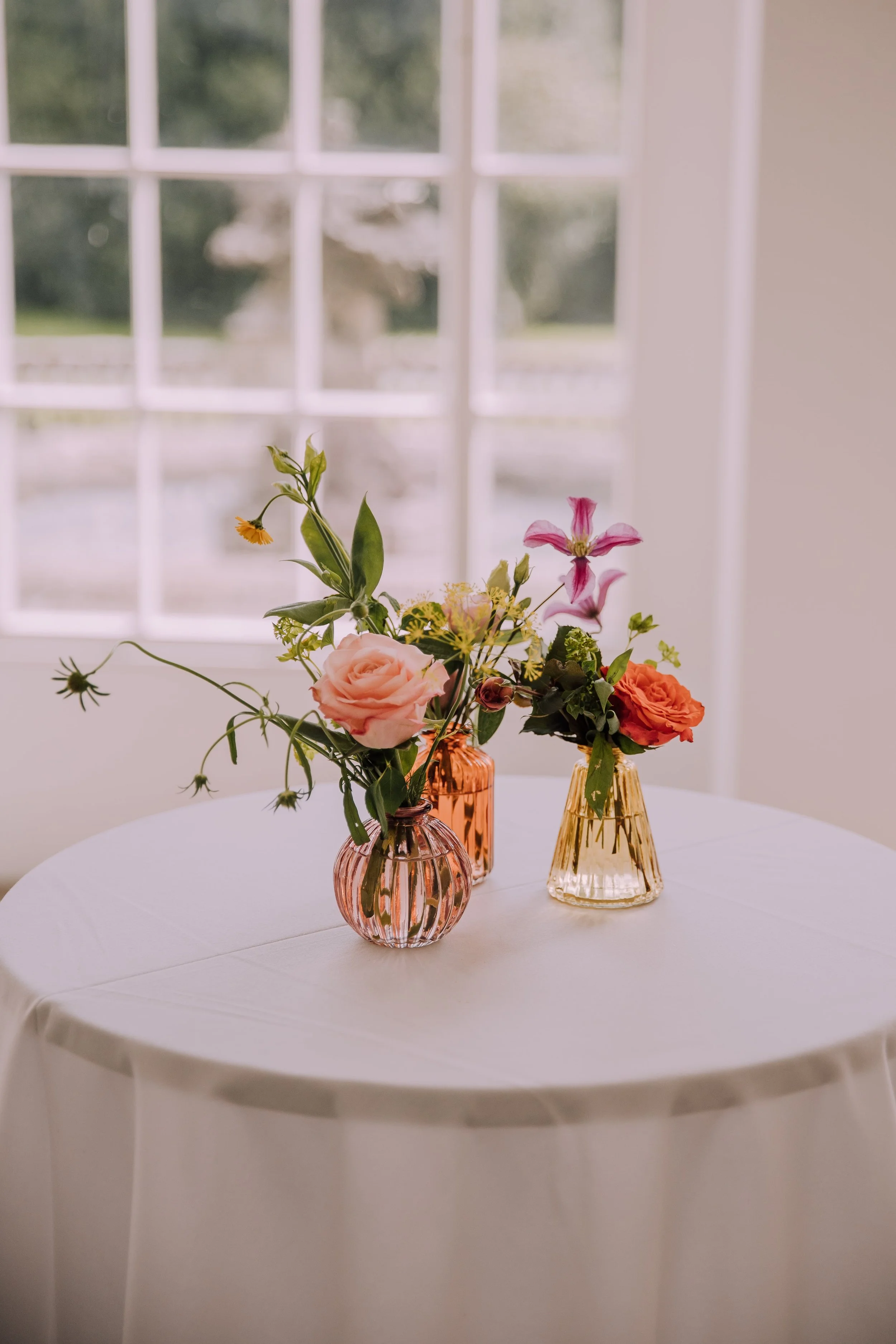 Bud vases with colourful summer wedding flowers.jpg