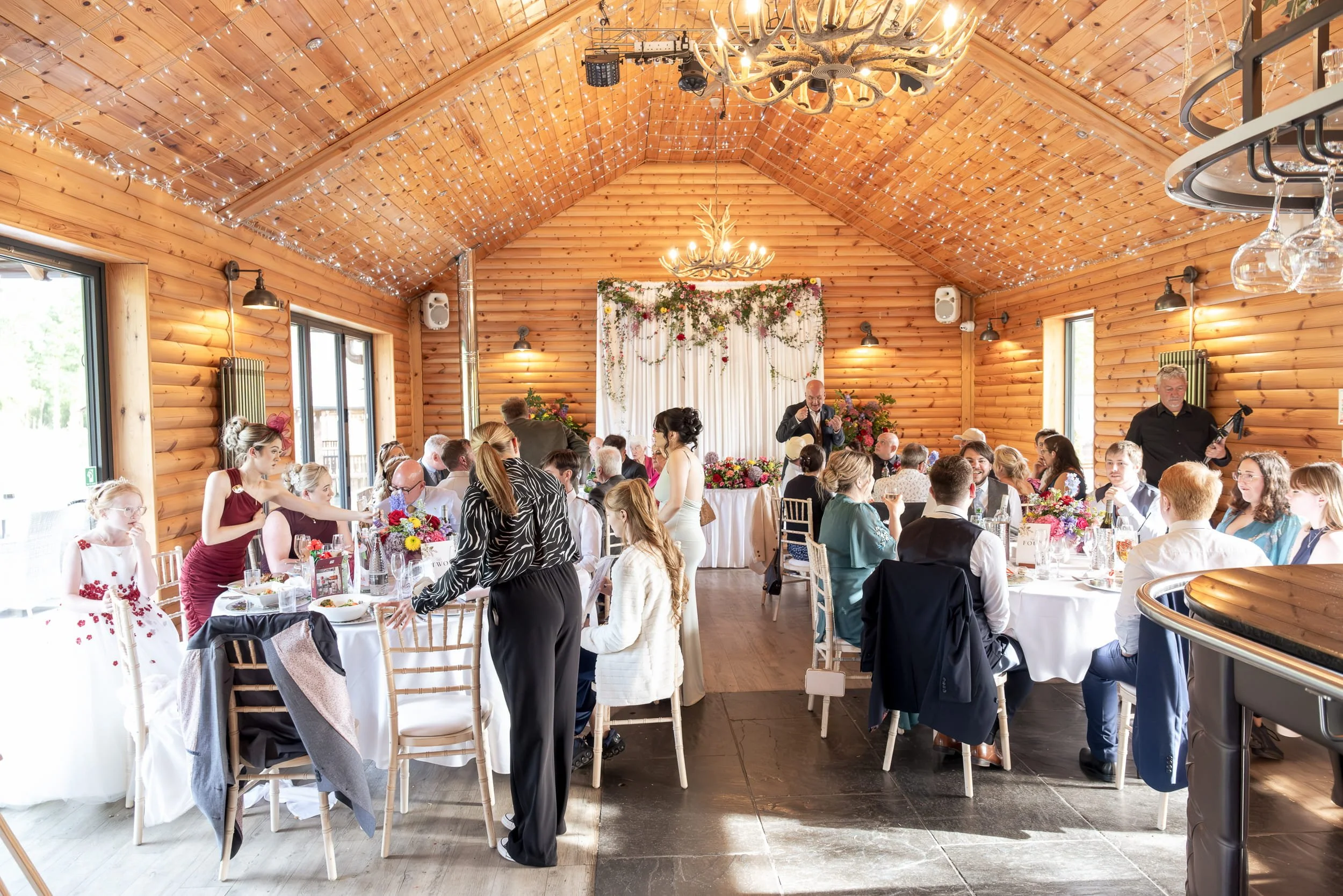 Colourful reception flowers for same sex wedding at Rhodri's by the Lake Canada Lodge, Cardiff