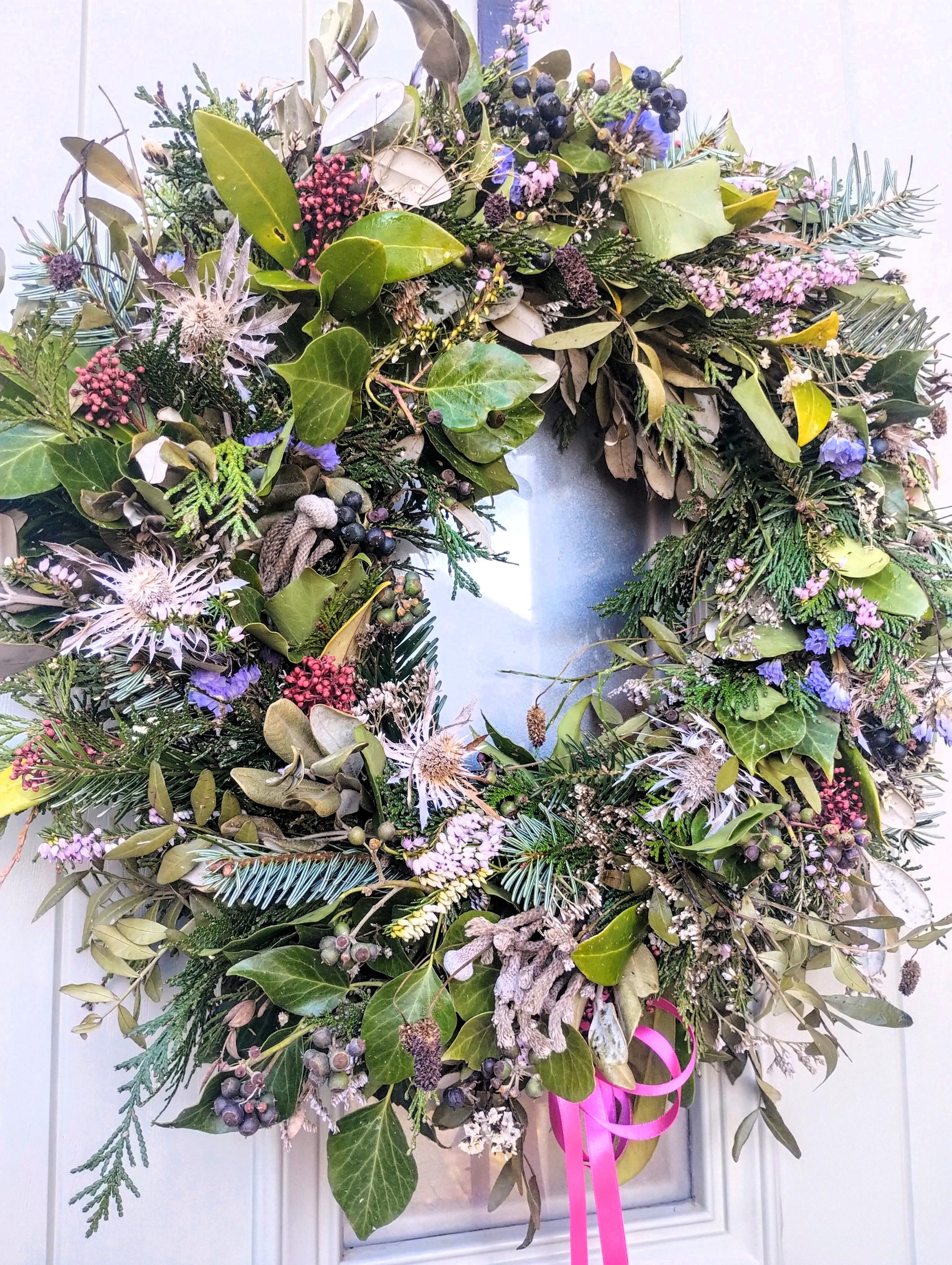 A Christmas wreath full of mixed foliage all supplied by Petal Power Cardiff workshops