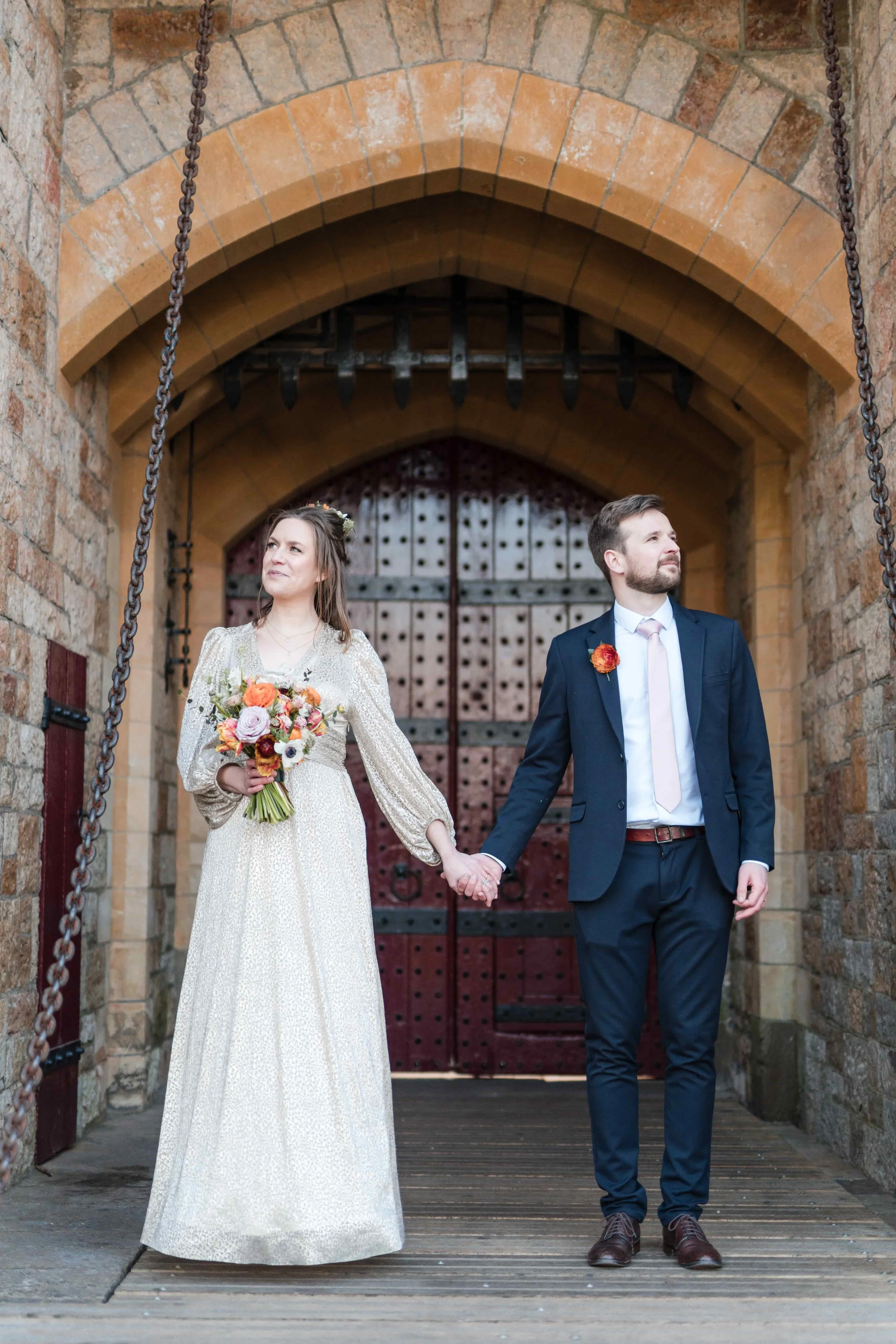Wedding couple with bright summer wedding flowers at Castel Coch