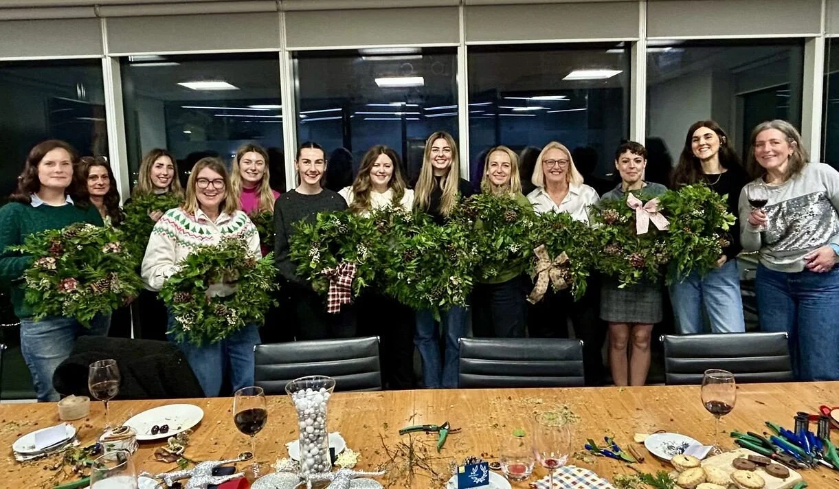 The office christmas wreath class with their finished wreaths