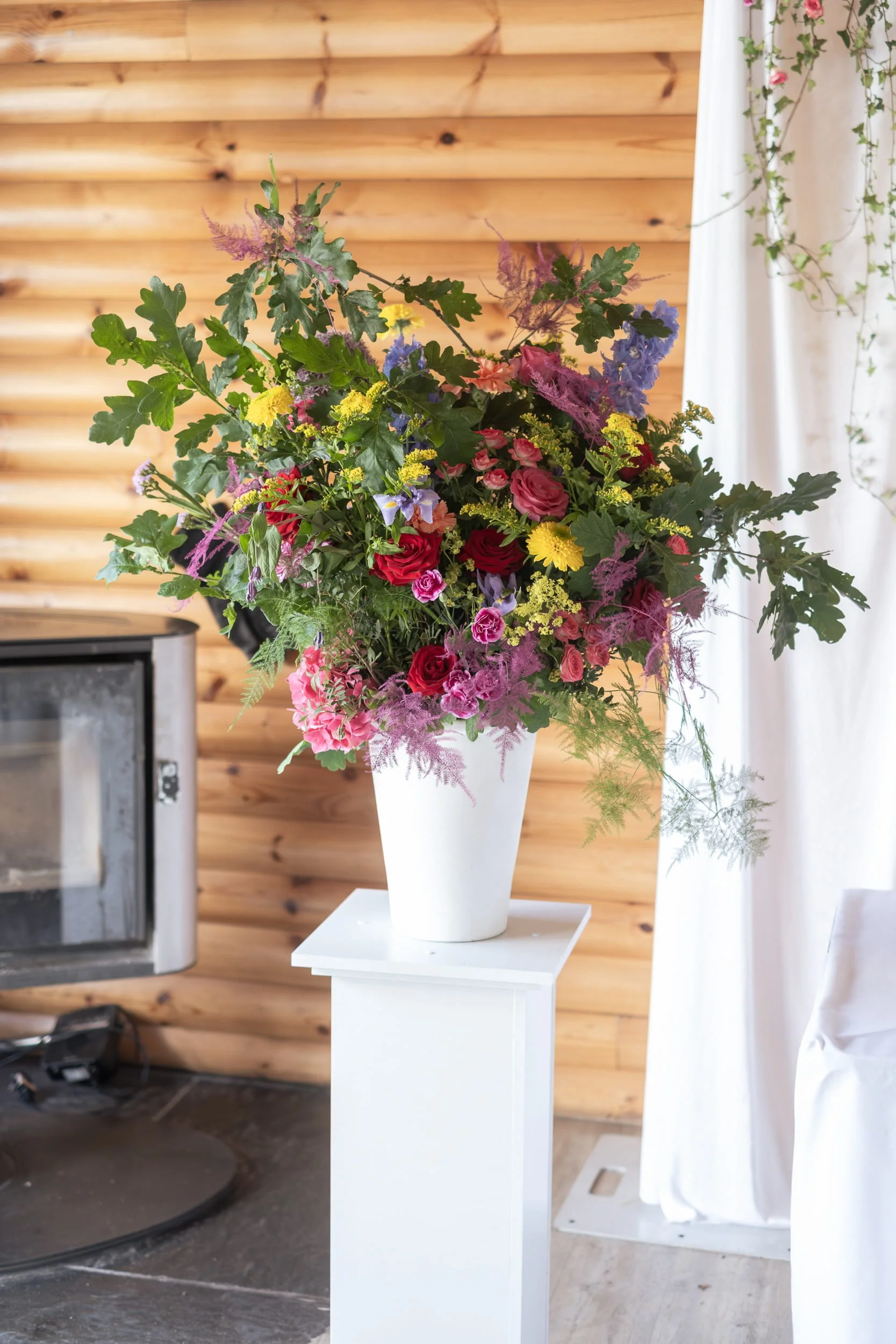 Floral urns full of colourful flowers line the ceremony area