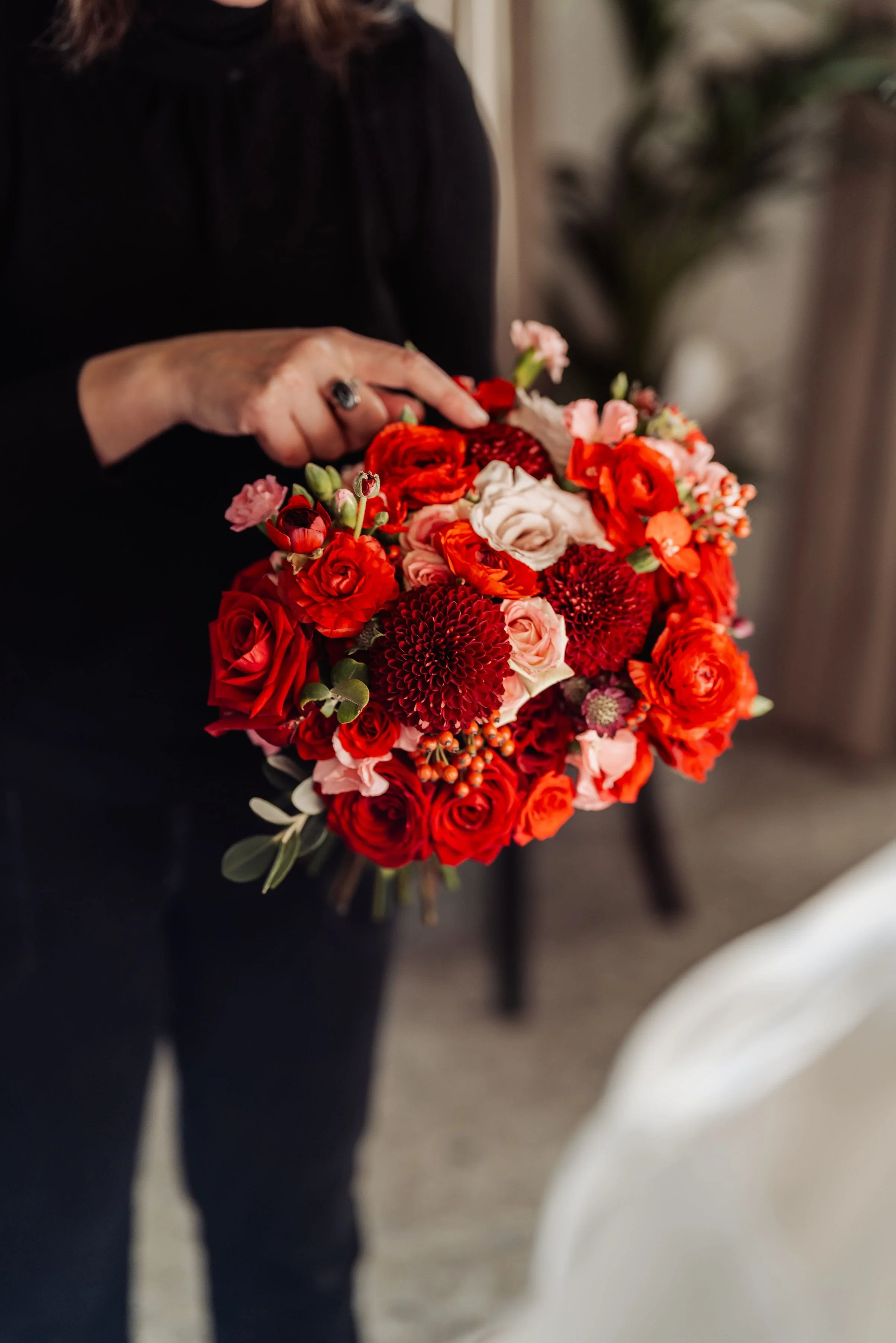 The bridal bouquet for Hensol Castle wedding full of burgundy chrysanthemums, deep red hearts roses, soft pink quicksand roses, ranunculus, dianthus and rose hips