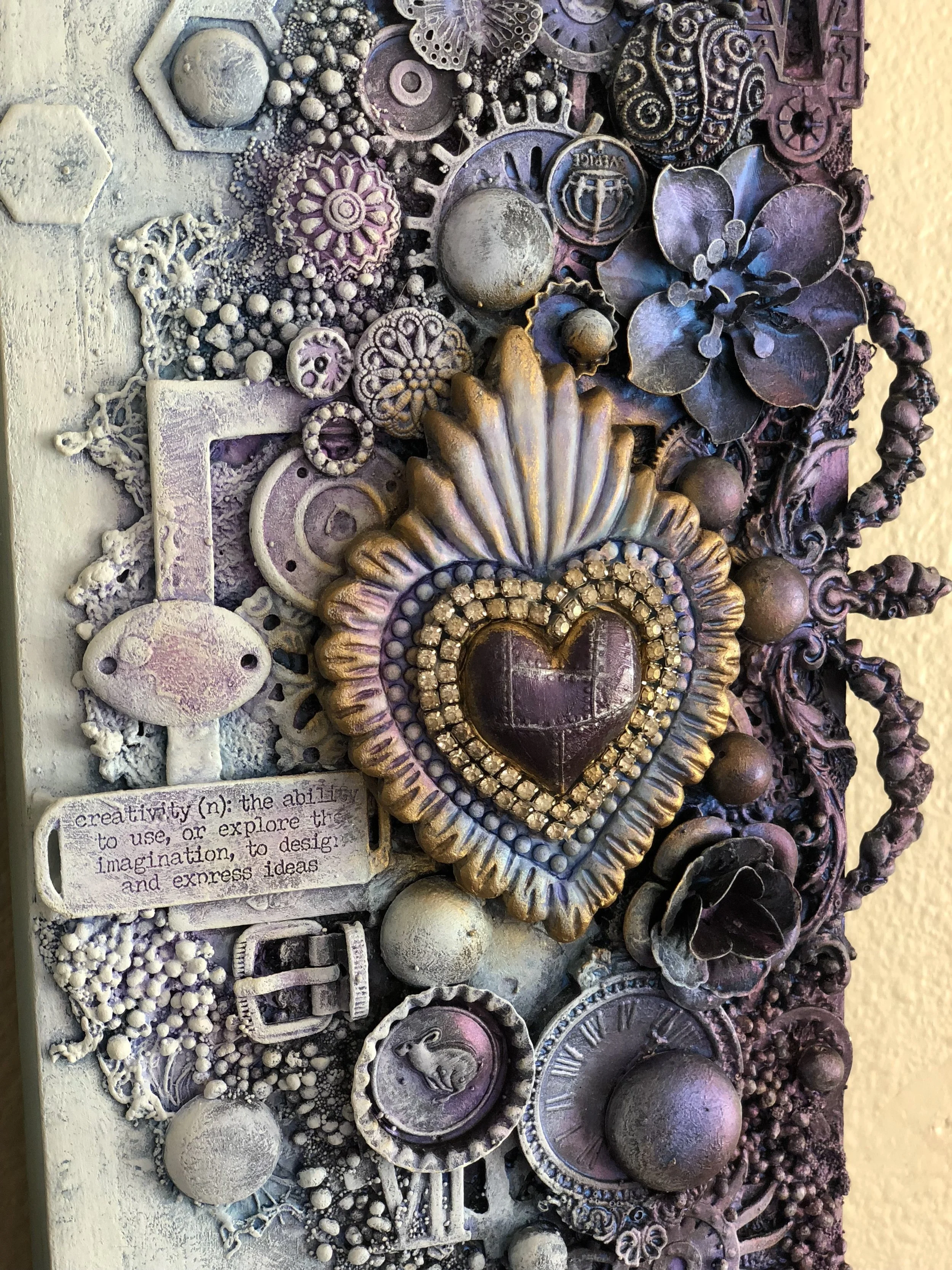  This beautiful piece is on 6x12 canvas displayed in my home.  It radiates an eclectic ray of items that I just had in my stash focusing on the crowning of the heart.  These beautiful colors add such a unique look and frames it. 