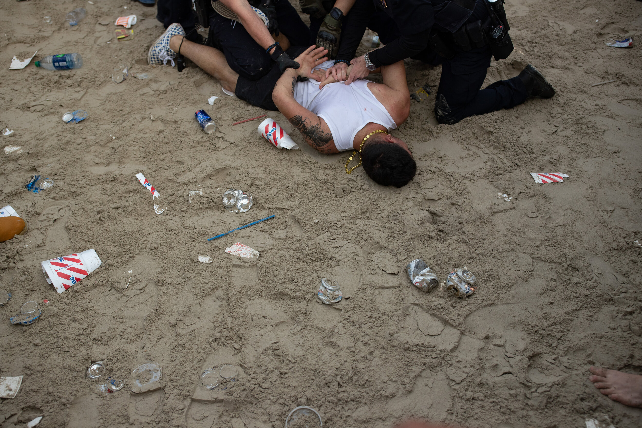  Police take a man in to custody on the beach after breaking up a fight during spring break 2019 in Port Aransas on Tuesday, March, 12, 2019. 