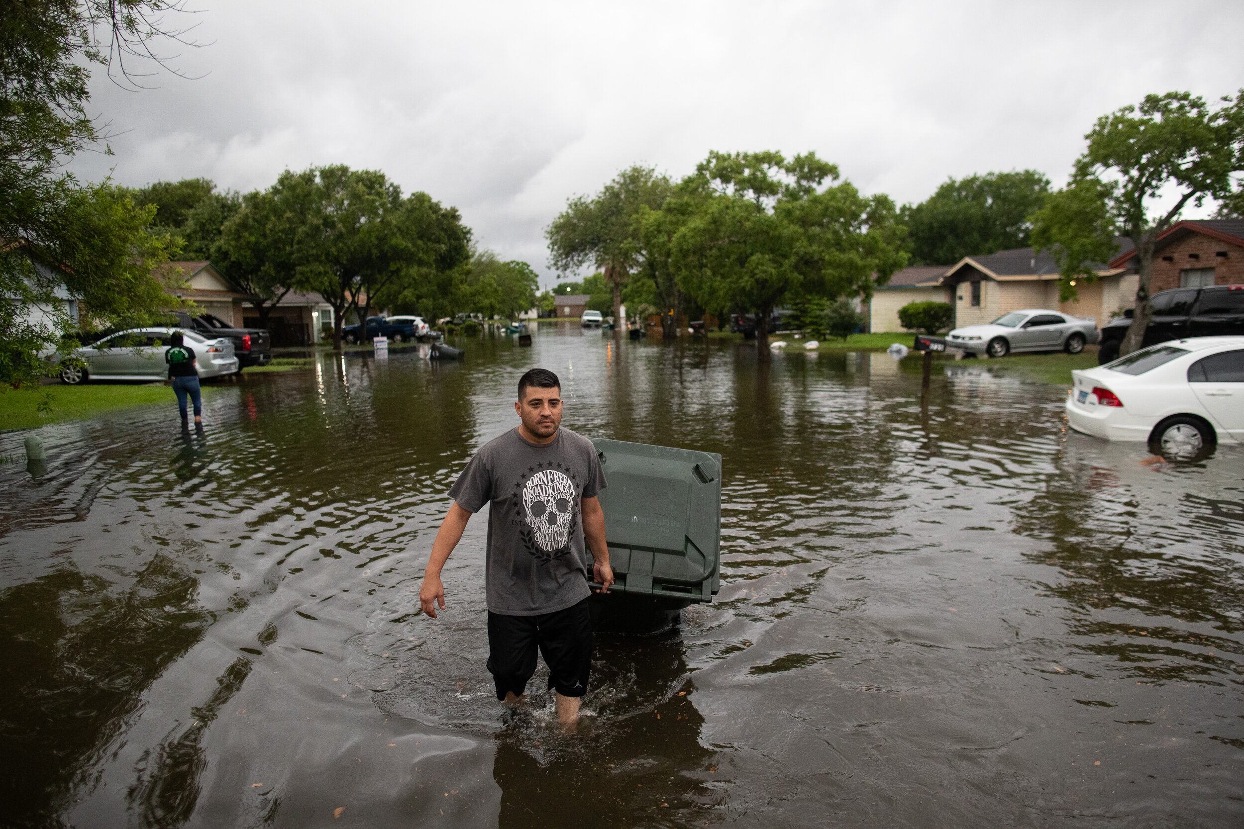  Pedro Banada pulls his garbage can that floated down a flooded Sun Beam Drive after heavy rains fell in the early morning on Friday, May 10, 2019.  