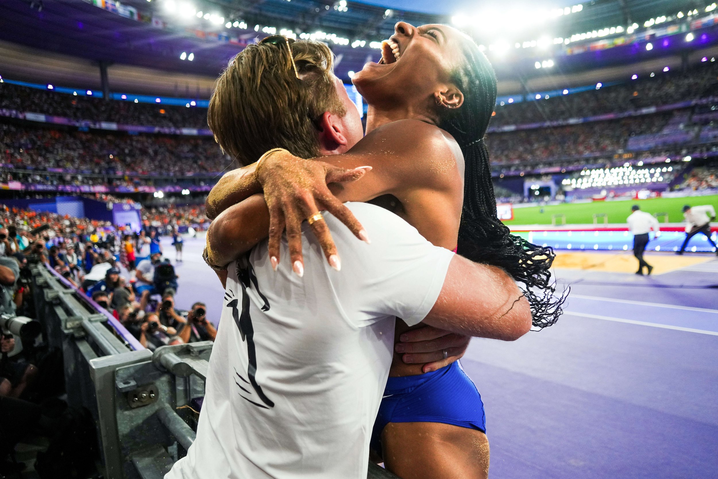Tara Davis-Woodhall of the United States celebrates with her husband Hunter Woodhall after winning the gold medal in the women’s long jump final at the 2024 Summer Olympics on Thursday, Aug. 8, 2024 in Saint-Denis, France.