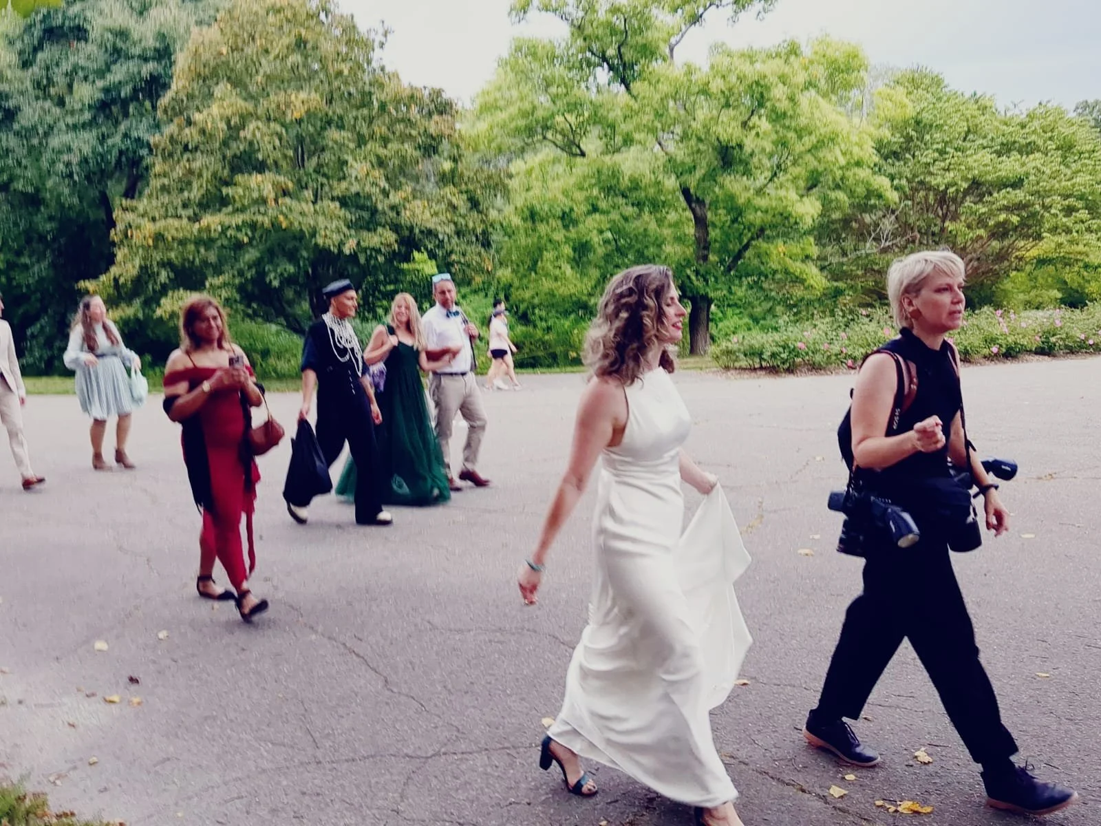 Sasha the wedding photographer guides the bride and friends across the Arboretum for photos