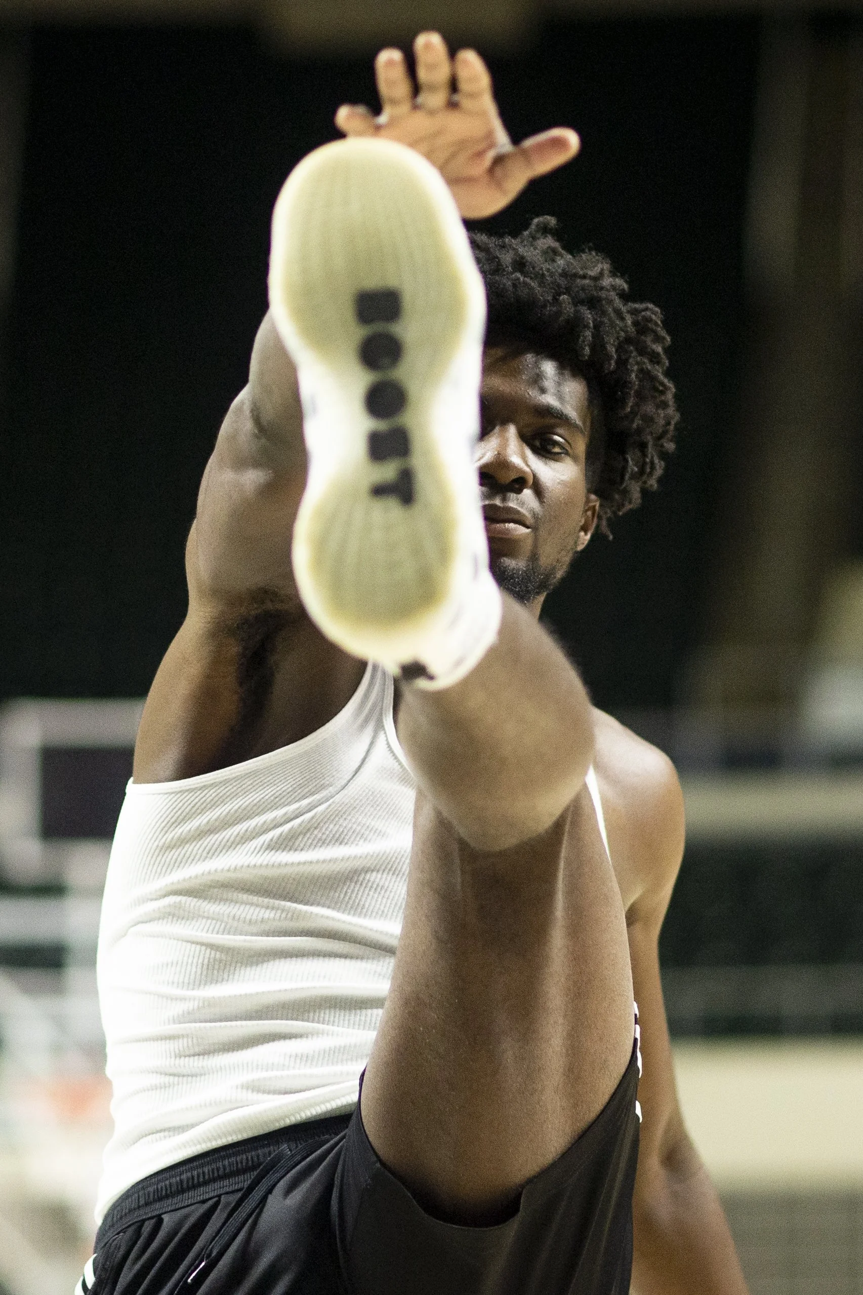  Olumide Adelodun (10) warms up prior to an optional Wednesday lift. The focus on the day was legs so it was imperative that Adelodun got the legs moving early  