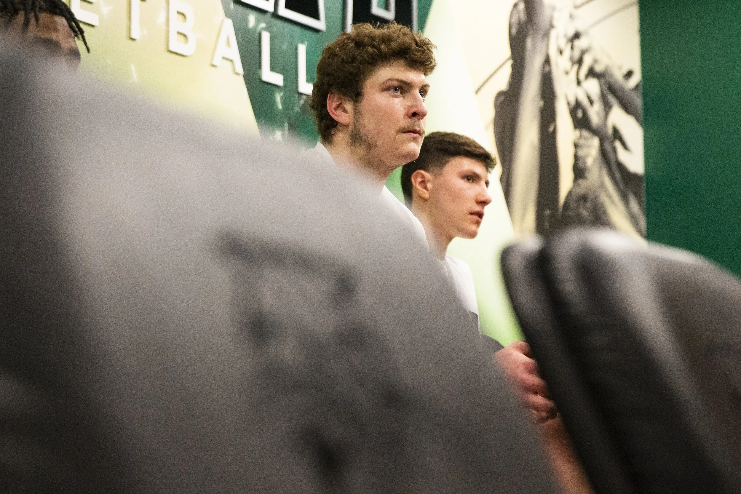  Ohio forward Colin Granger (32) and guard John Tenerowicz (12) listen to the pregame speech from Coach Jeff Boals.  