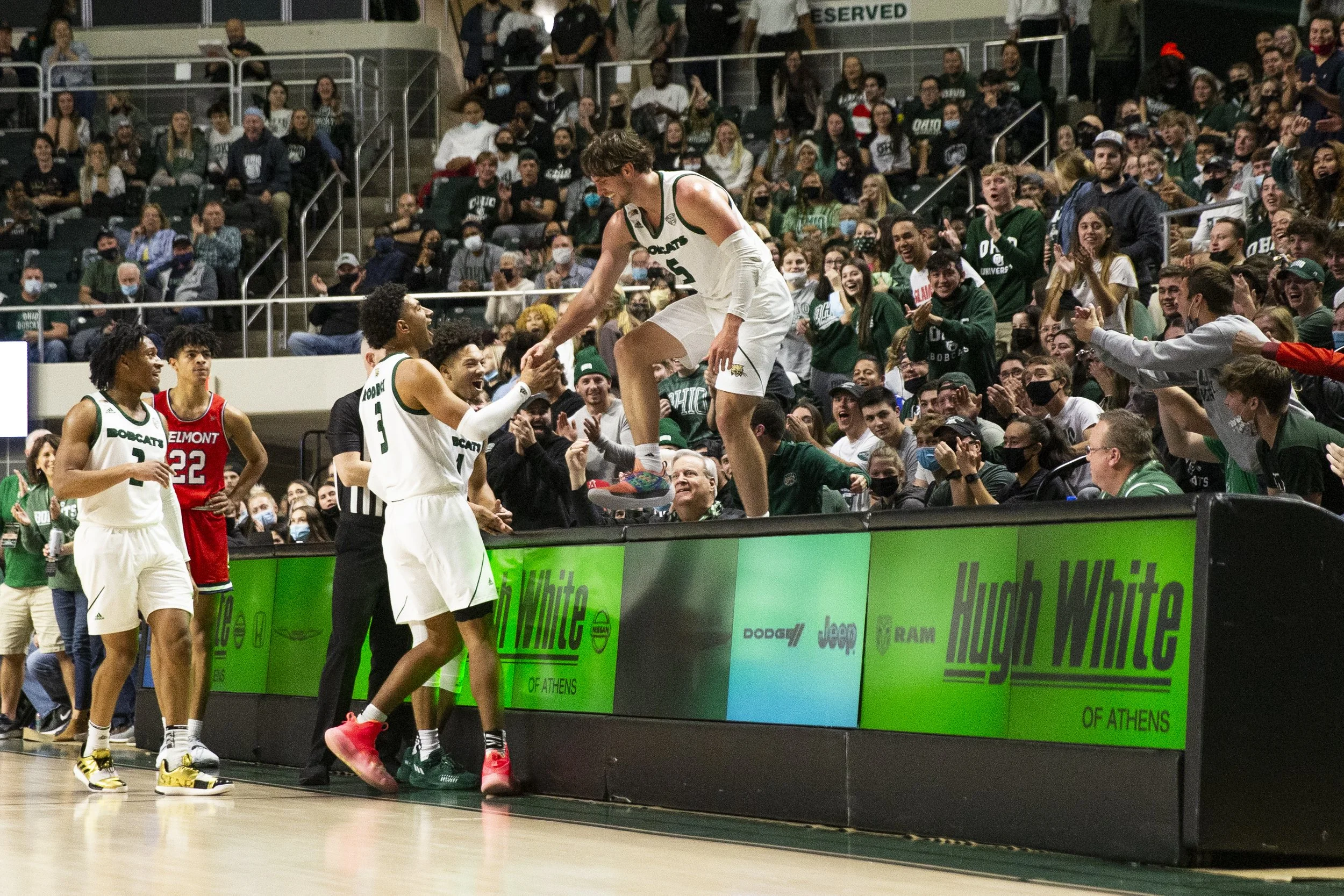  Ben Vander Plas is helped up by teammates Ben Roderick and Mark Sears after taking a tumble over the scorer’s table during the first half of the game against Belmont.  