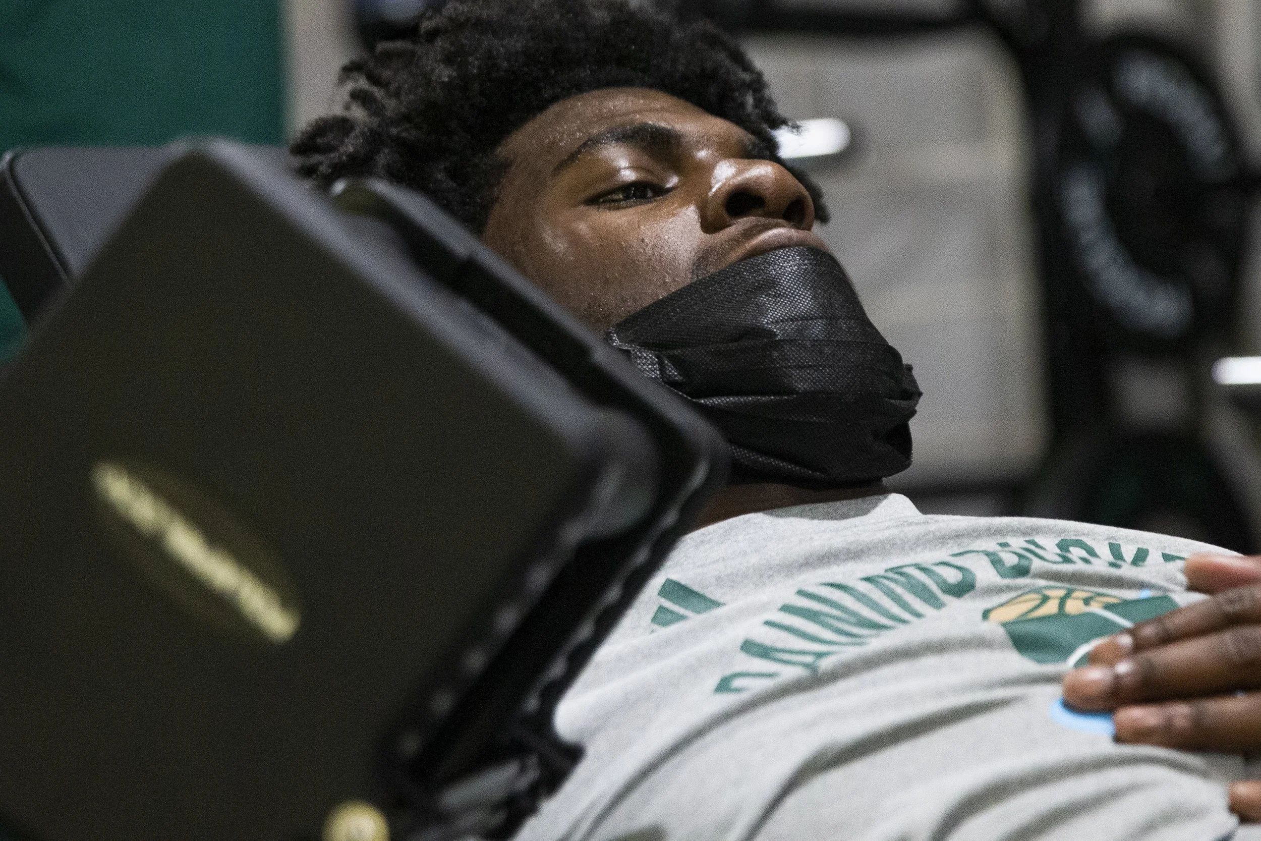  Olumide Adelodun preforms a dumbbell chest-press during a Thursday workout. Being a freshman, Adelodun is working out to increase muscle mass in order to compete with some of the larger players in the MAC.  