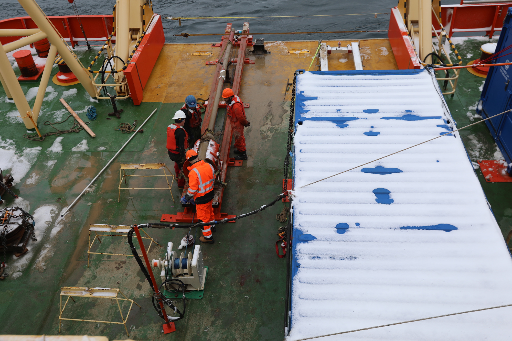 THOR team members Rob Larter, Becky Totten Minzoni and Ali Graham look over the jumbo gravity core collected on the 28th of February.