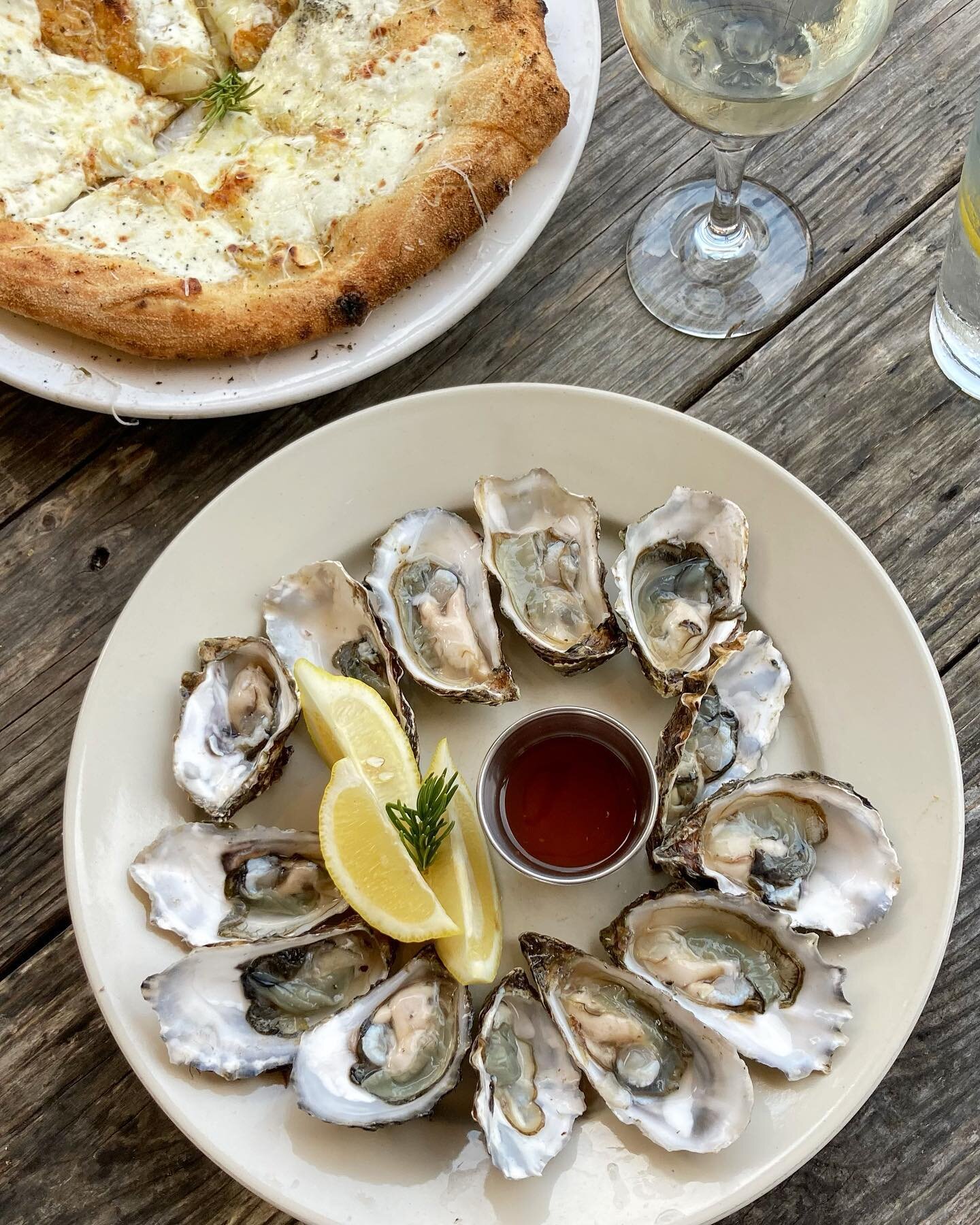 Celebrating the end of {Covid} isolation with a favorite escape &hellip;. fresh shucked briny oysters with a tangy mignonette, perfectly garlic-y cheese-y herb bread, a glass of chilled dry white &hellip;. and the joy of regaining the sensation of ta