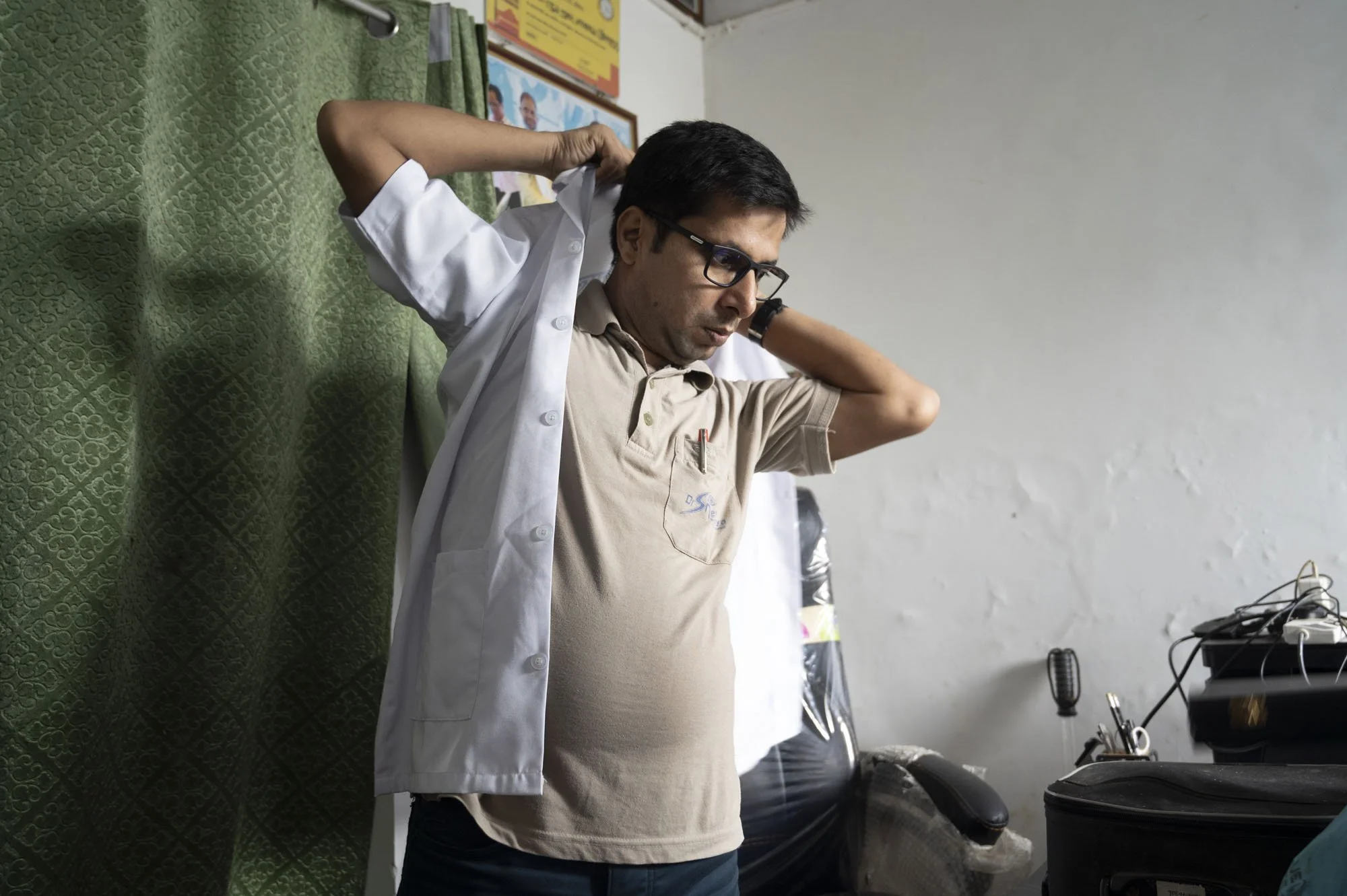 Multi-skilled ophthalmic worker Umesh sets up in an abandoned part of the home of the village mukhyia.