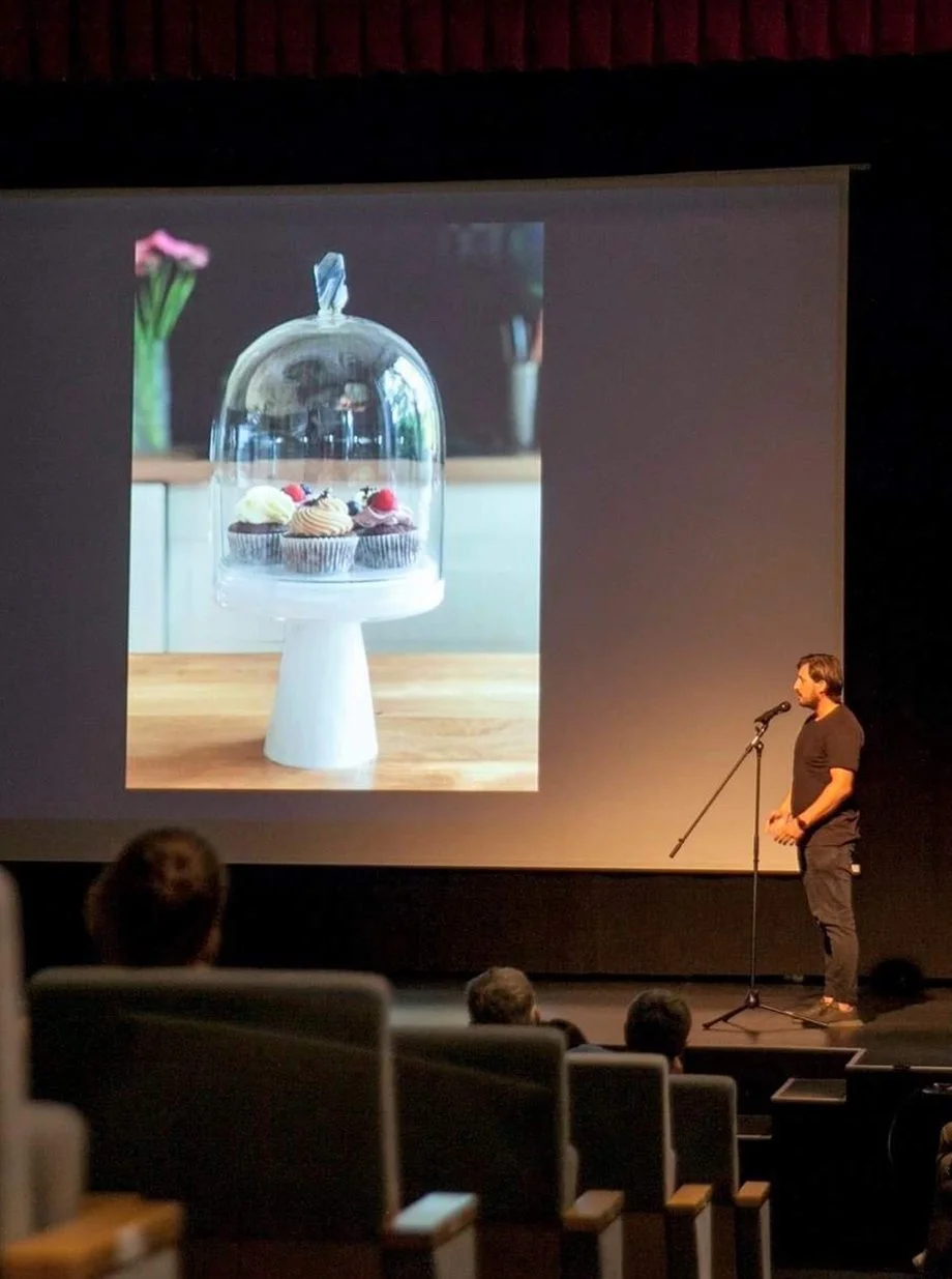 Founder presenting the Sugaar & Sugaar story with glassware image projected behind.