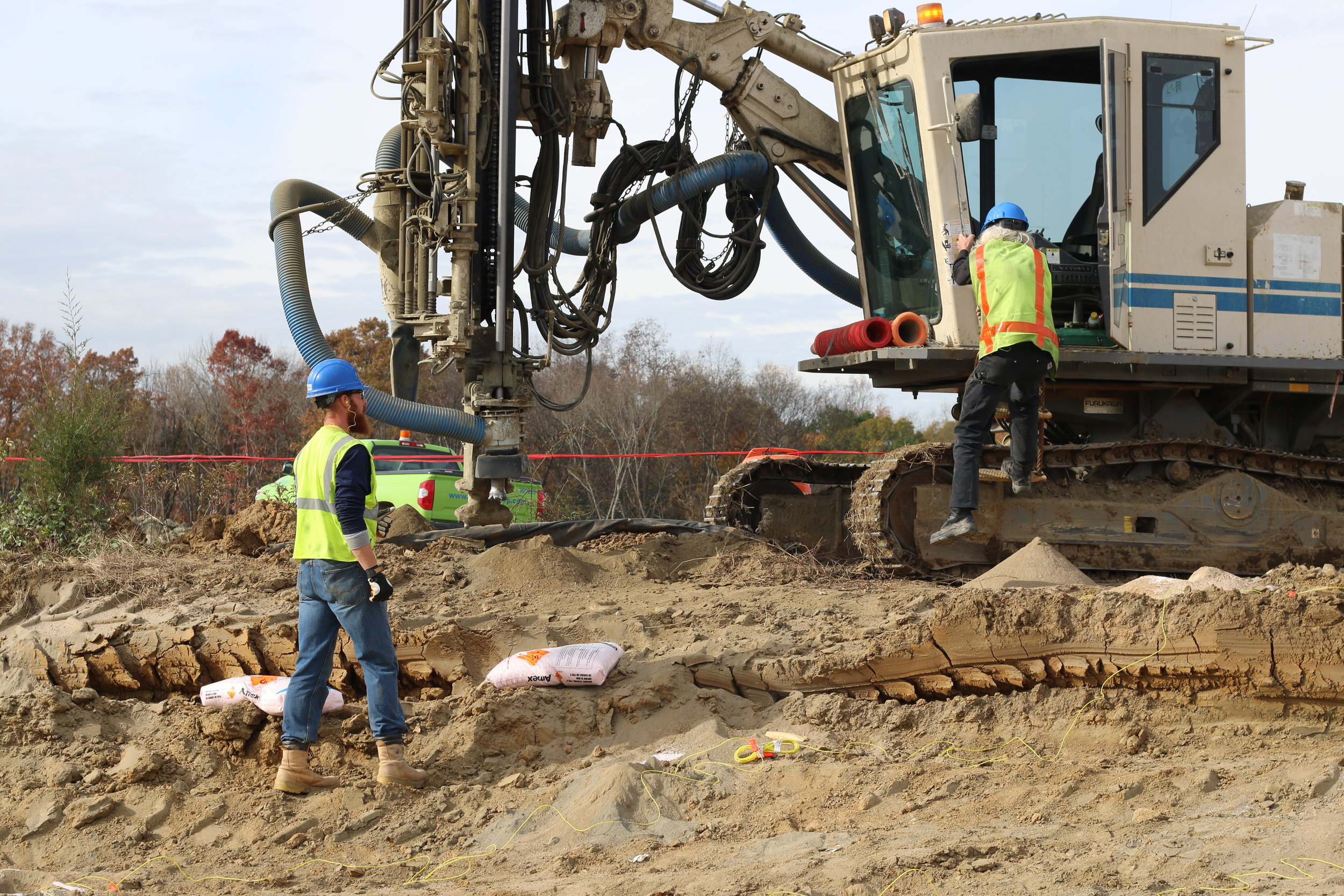 workers with a Furukawa drill rig at a project site