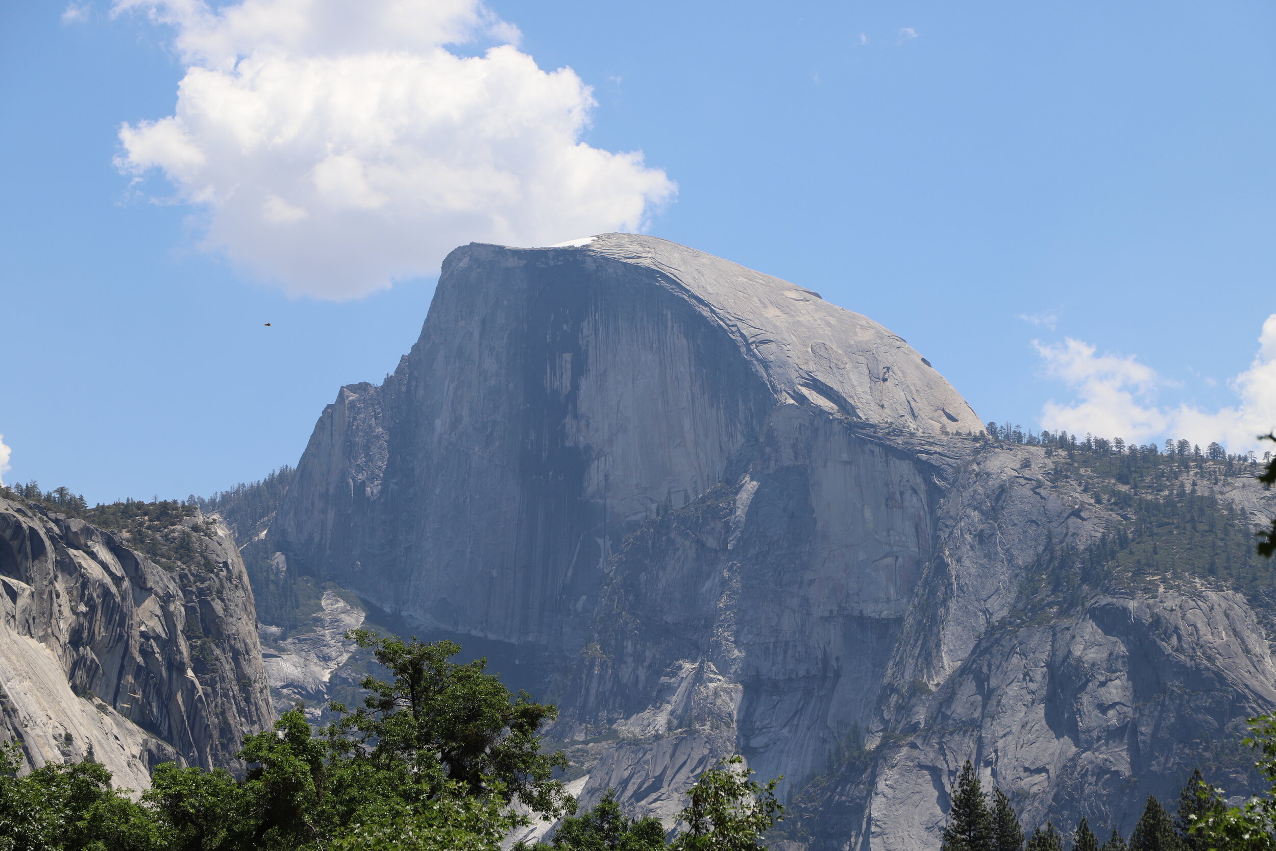 This is Half Dome. You’ll see it in several pictures as it is visible from several parts of the Panorama Trail. The cables to the top are on the back side of the mountain (not visible in the picture).