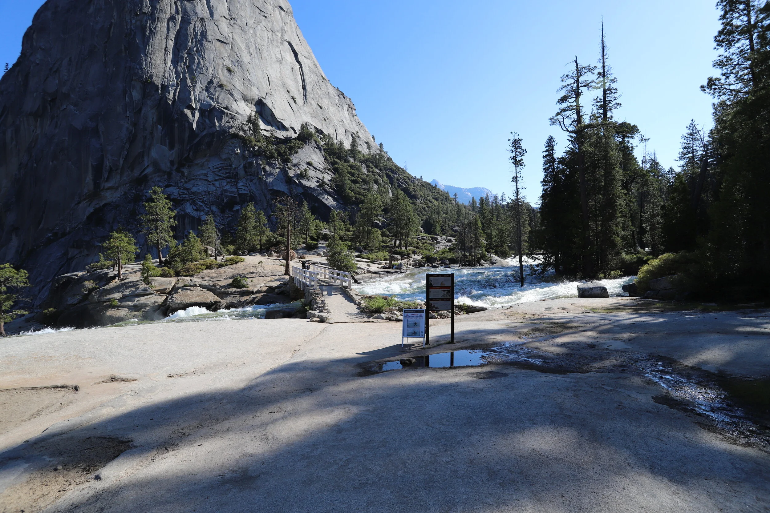 This is the top of Nevada Falls. The water is flowing extremely fast here. The trail crosses over the river on another bridge.