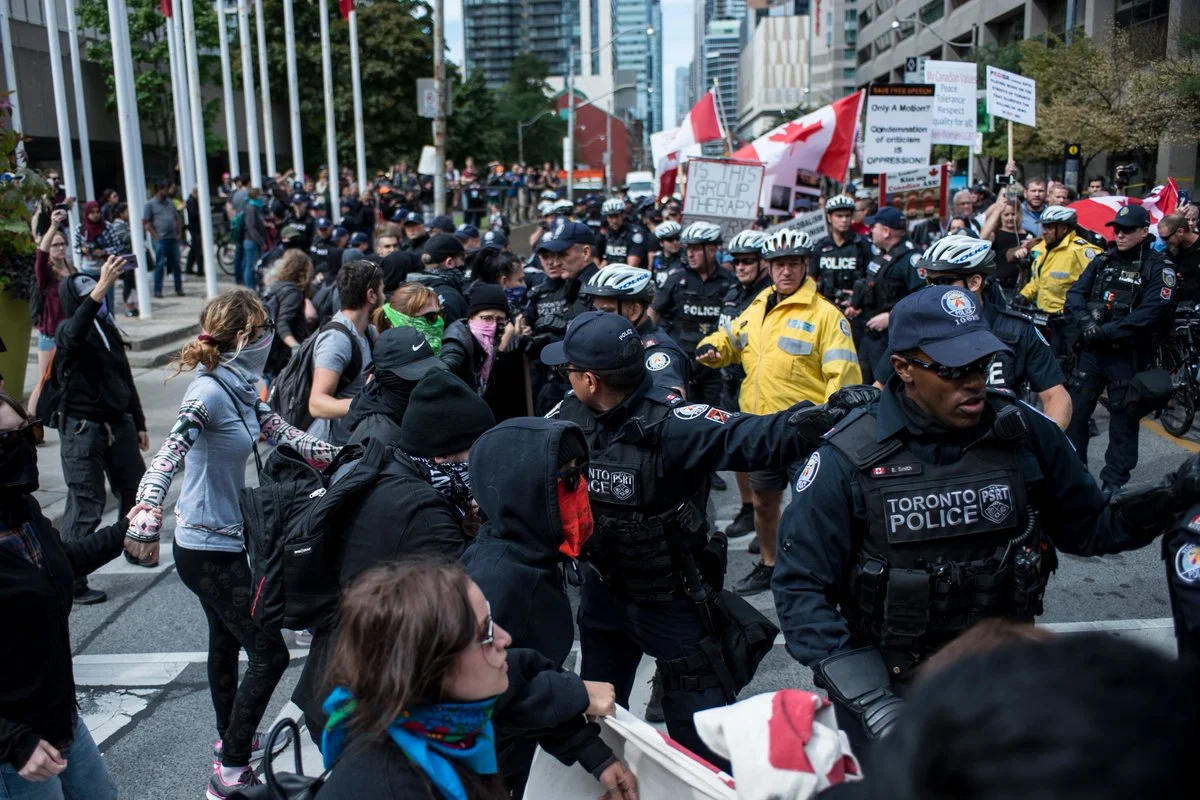 The protest line eventually breaks and counter-demonstrators scramble to form another line to prevent PEGIDA from placing a wreath at old City Hall. (ALI JAVEED/ THE UNDERGROUND)