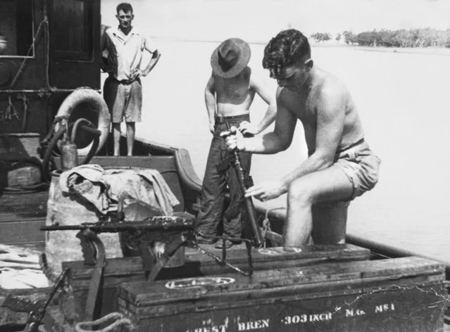 SRD on board Krait cleaning checking weapons before their attack on Singapore in 1943 in the photograph are Mark 1 42 Owen machine guns They appear to have been painted black.jpg