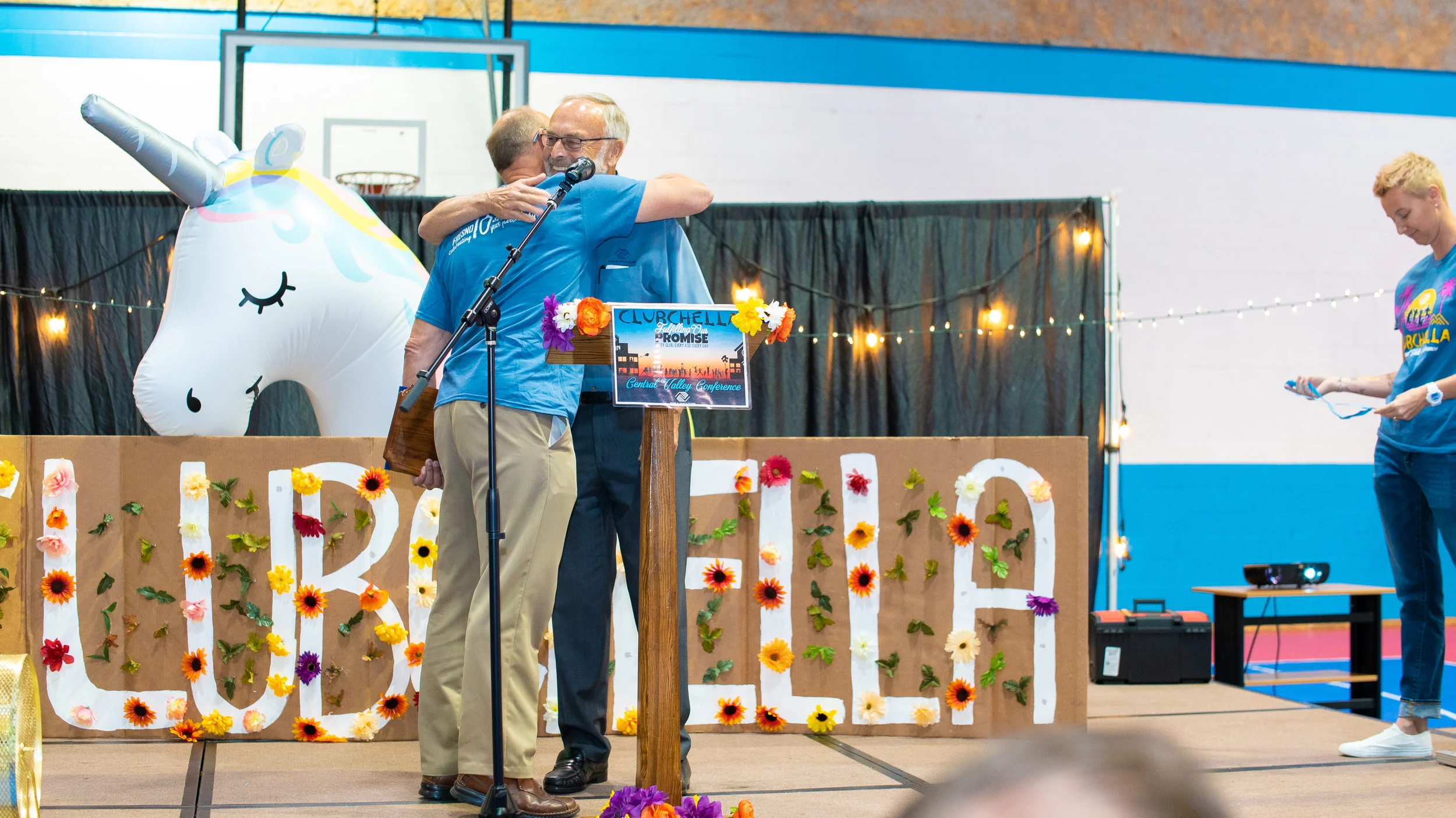 Ken Quenzer embracing his son, Galen Quenzer, after having awarded him an honorary plaque.