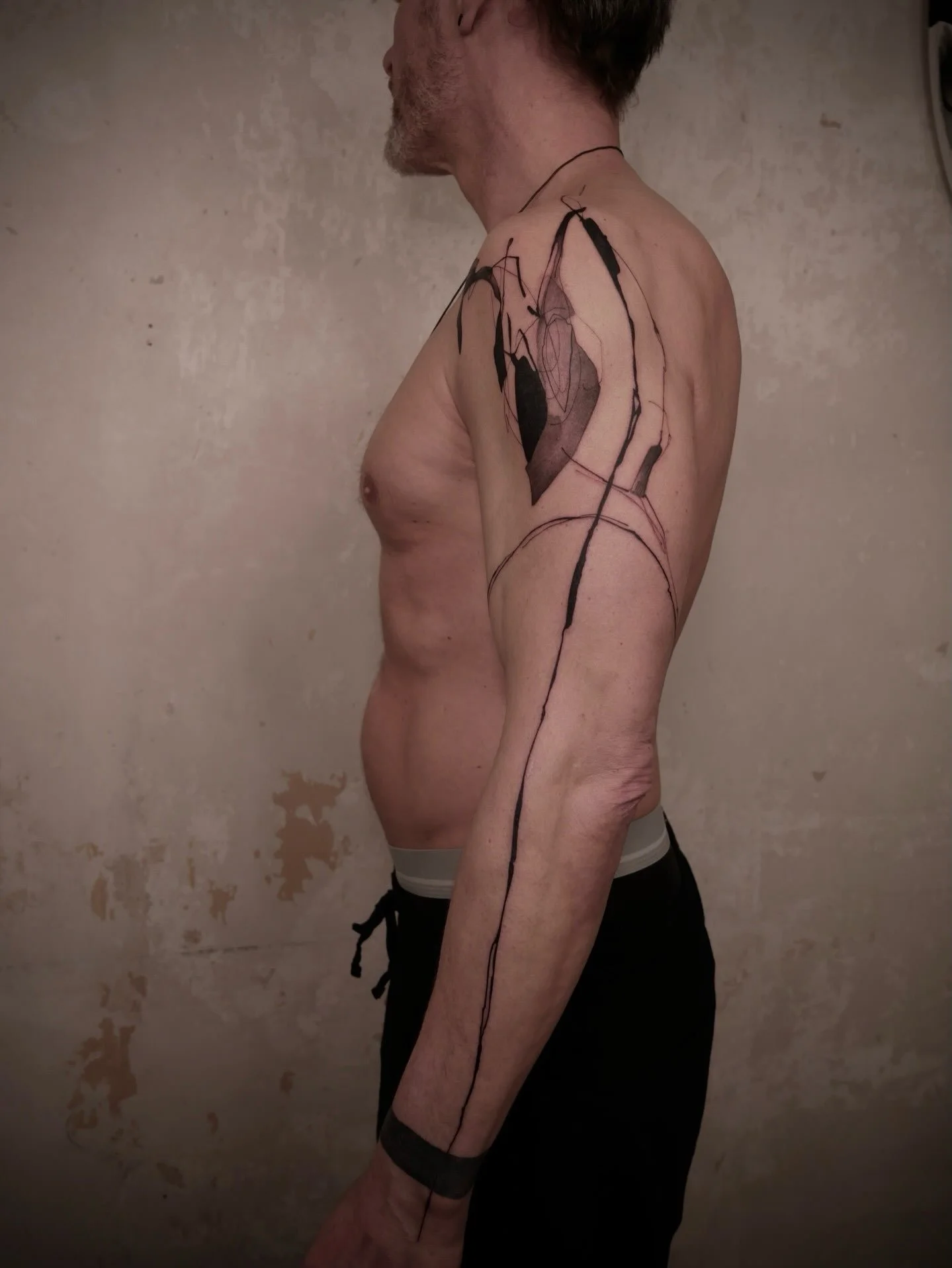 @sionaxttt 

This work is in pure abstraction, where nothing is depicted and everything is felt. One long line falls the length of the arm like a plumb line, while dense black masses and translucent washes pull against each other. Fine, restless mark
