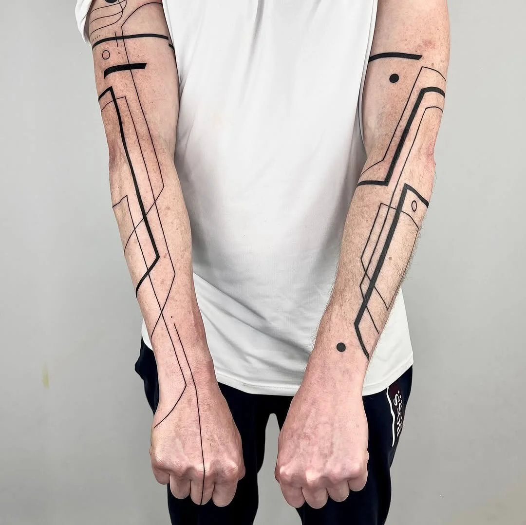 Line as the whole language 
@k8.black works with a single weight of black: loops that wrap the arm like orbits, angular paths that run the length of the forearms, and one straight line down the centre of the torso. Dots and breaks act as punctuation.