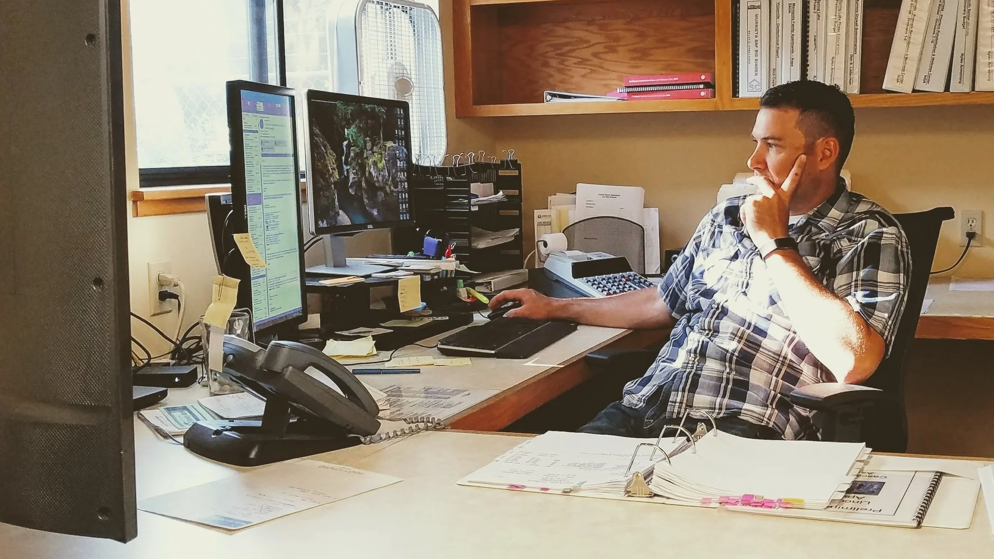 Chief Estimator, Nyles Armstrong, working on numbers