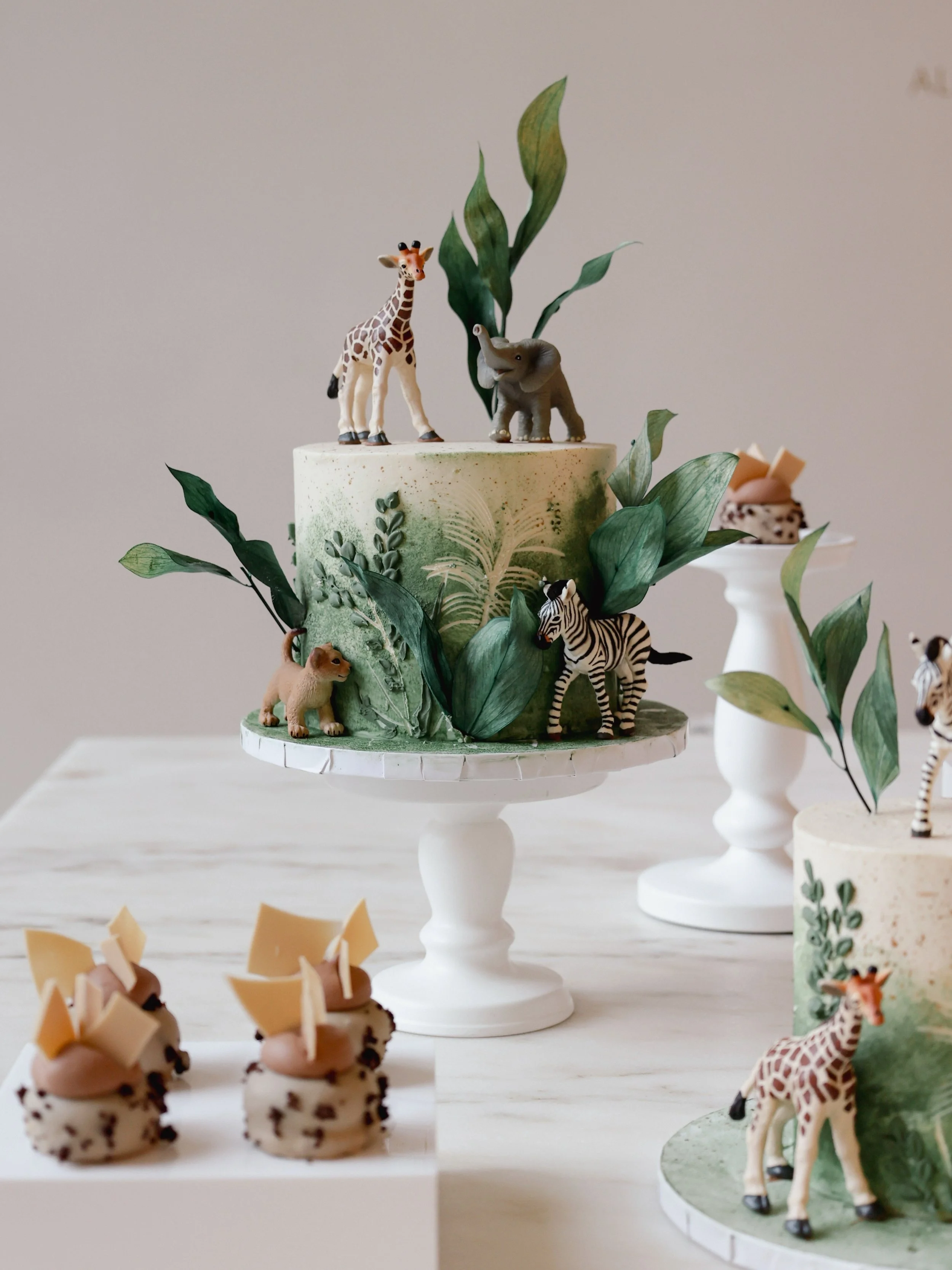Unsere individuelle Anfertigung im Dschungel-Motto mit Schleichtieren und dazu passender Mini-Patisserie 🦒🍃

#birthdaycake #munichcakes #babycakes #jungles