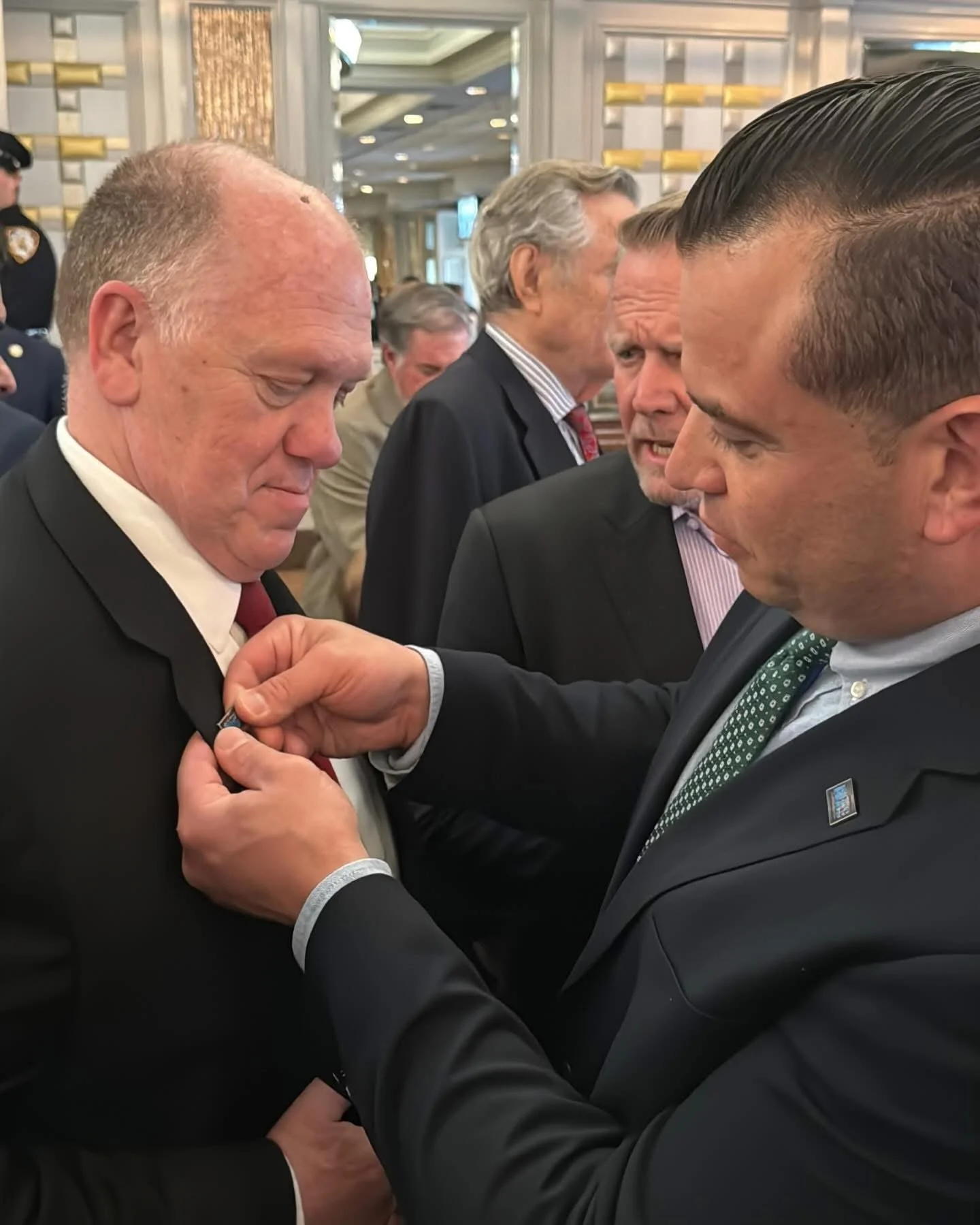  George Beck placing the BLUE pin on Tom Homan. 