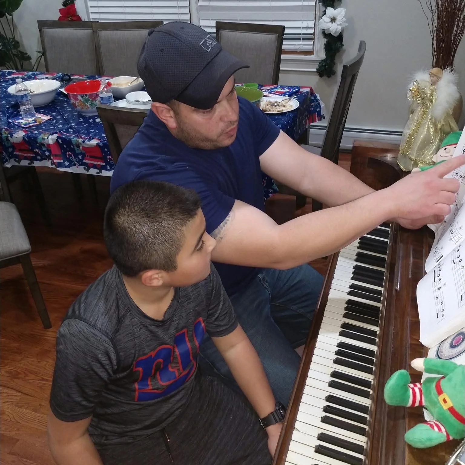  George teaching Daniel, Jr how to play piano. 