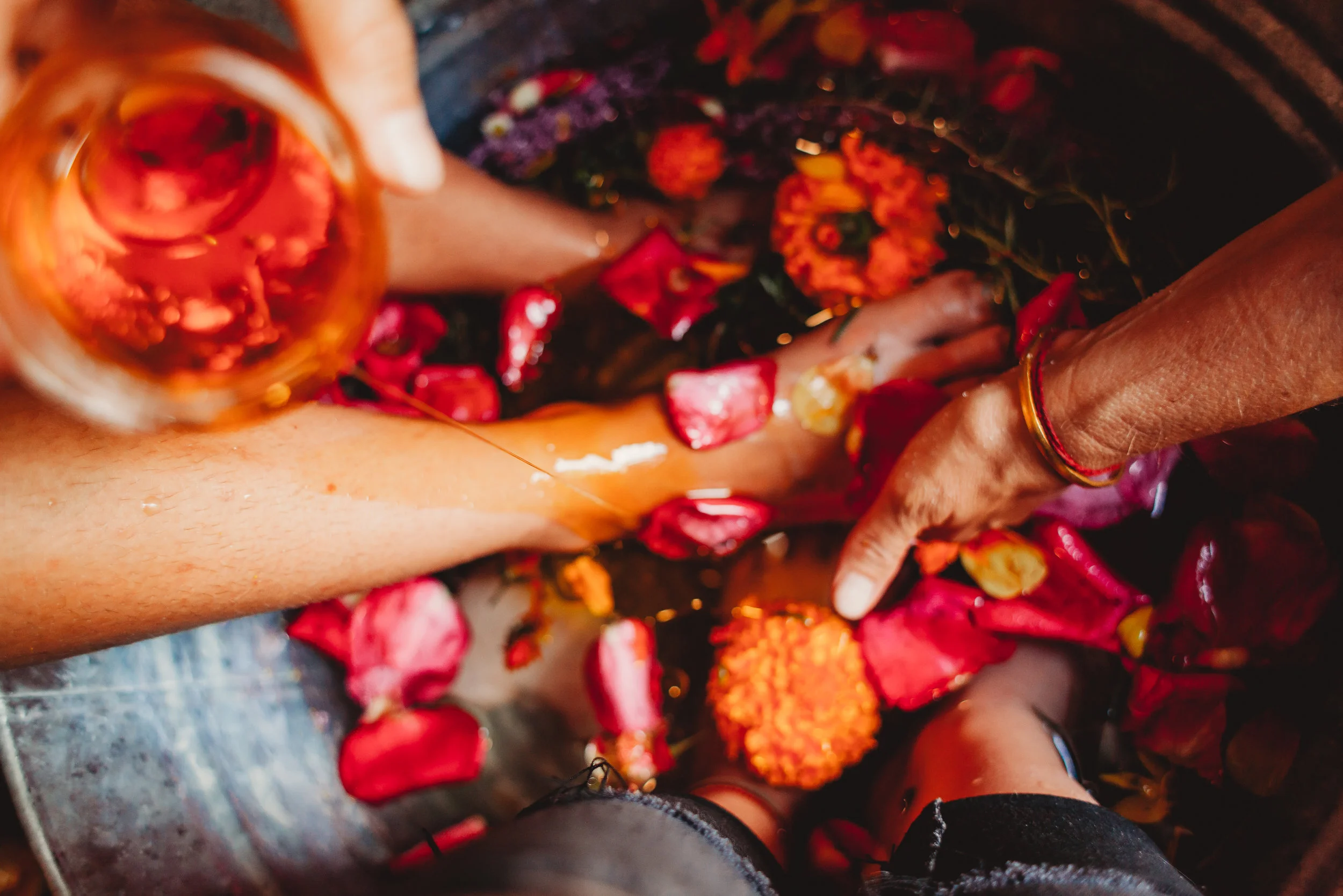 We begin with a flower and stone foot bath, adding some oil as you soak.