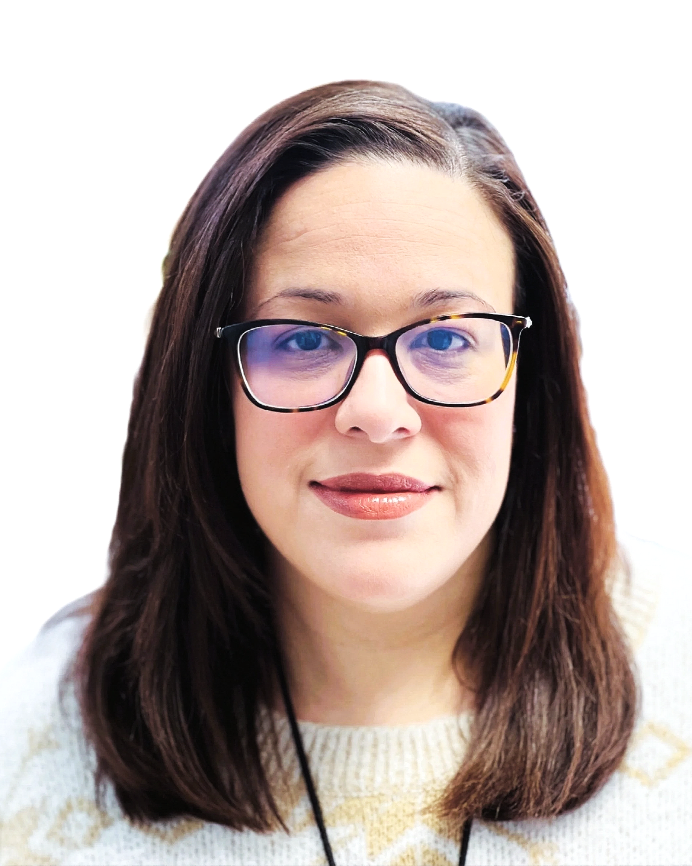 A woman with shoulder-length brown hair, wearing glasses with tortoiseshell frames, a beige sweater, and lipstick, looking at the camera against a white background.