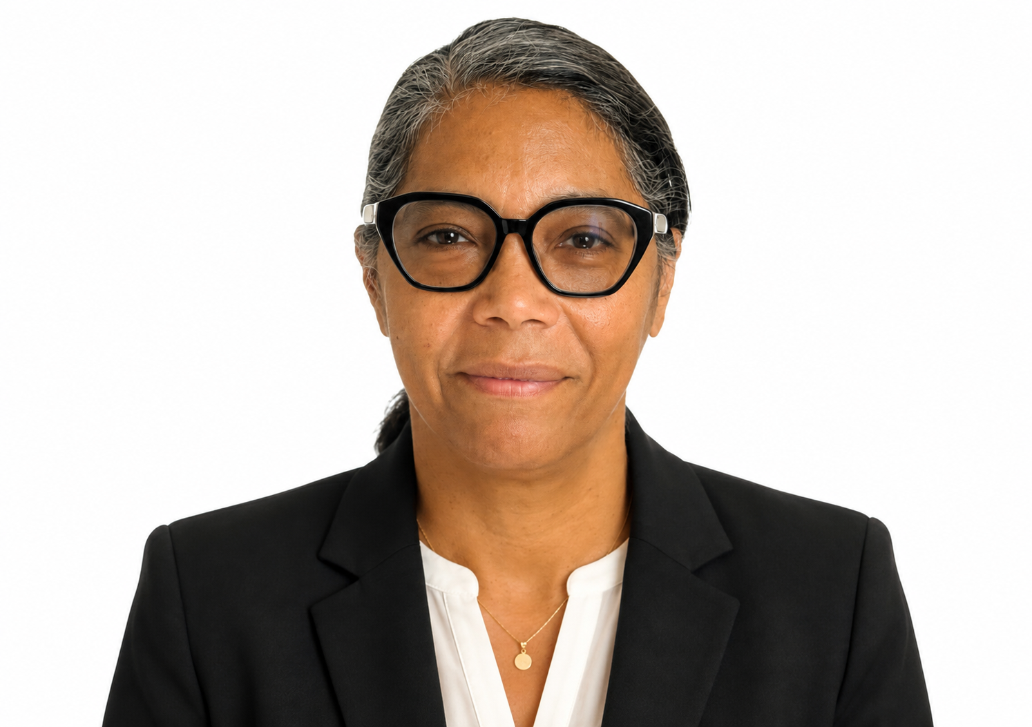 Portrait of a middle-aged woman with long gray hair, wearing thick black glasses and a light pink collared shirt, against a white background.
