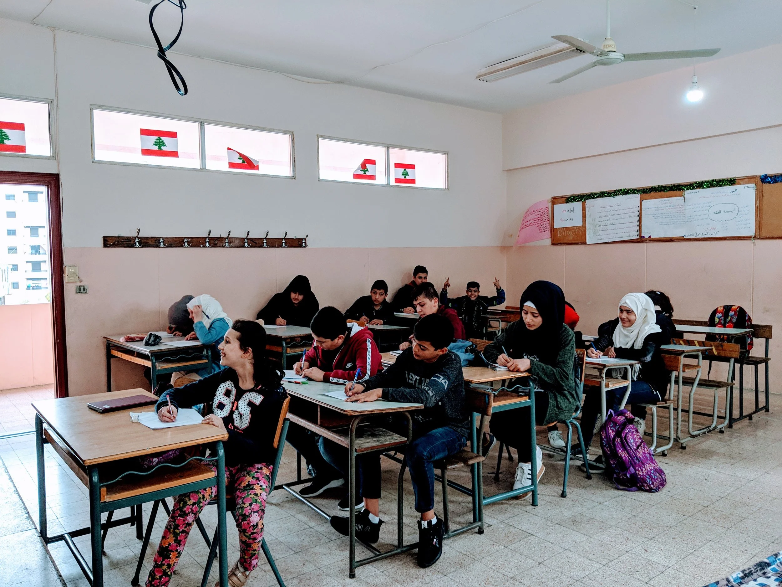 Syrian youth in in an English class in Saida, Lebanon. Not all displaced Syrians in Lebanon are eligible to attend school. Those that do have access to formal education attend classes in the afternoons, after the traditional Lebanese school day has finished. Many students, like most of those in this class, work as day laborers outside of their three hour learning window.