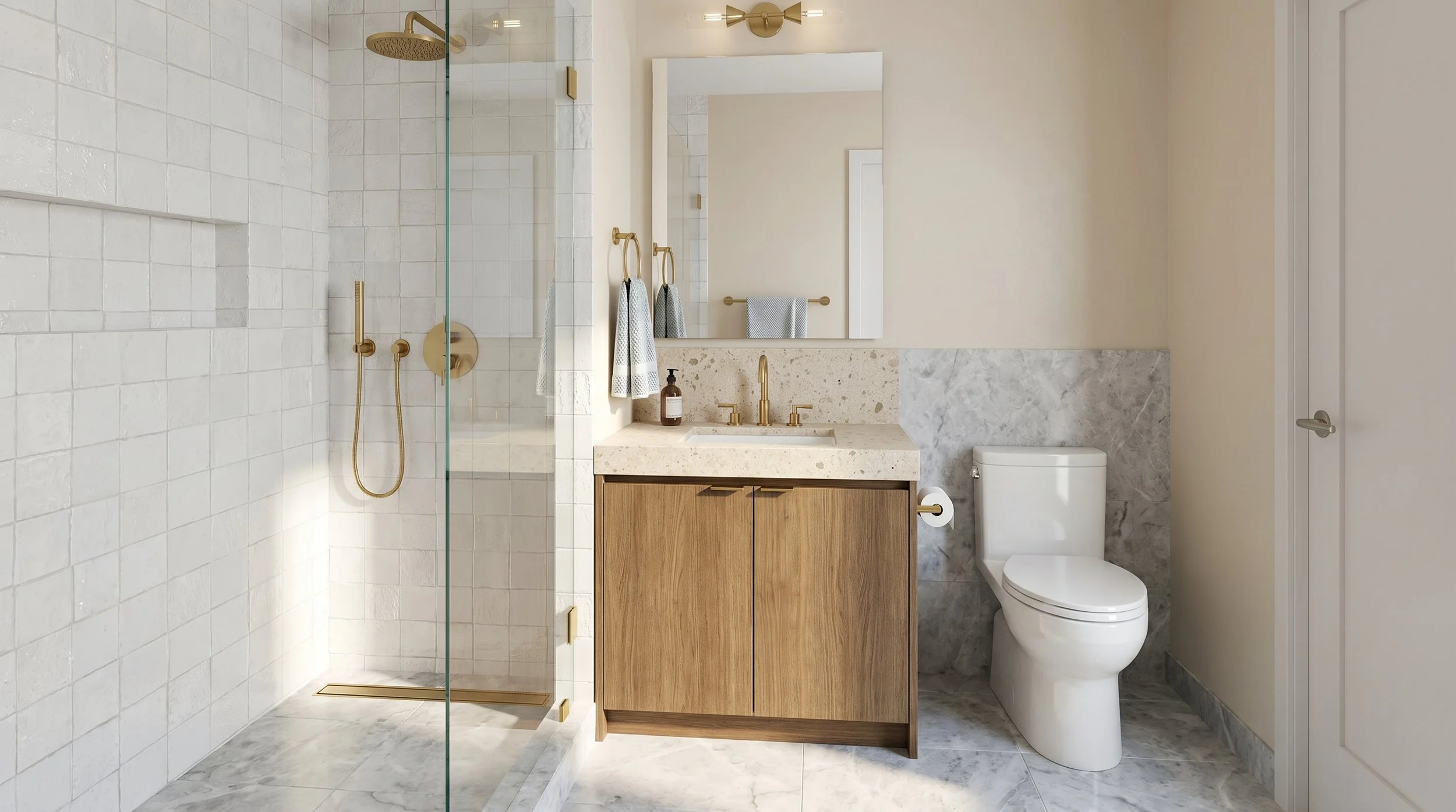 Modern bathroom with a walk-in shower featuring white tiled walls and a gold showerhead, a wooden vanity with a white marble countertop, a rectangular mirror, gold fixtures, a soap dispenser, a towel ring with towels, and a white toilet with a partially gray marble wall behind it.