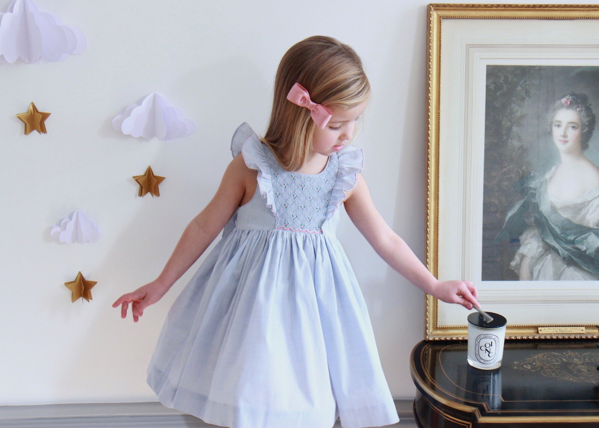 Blue Netti smocked dress with its delicate ruffles 